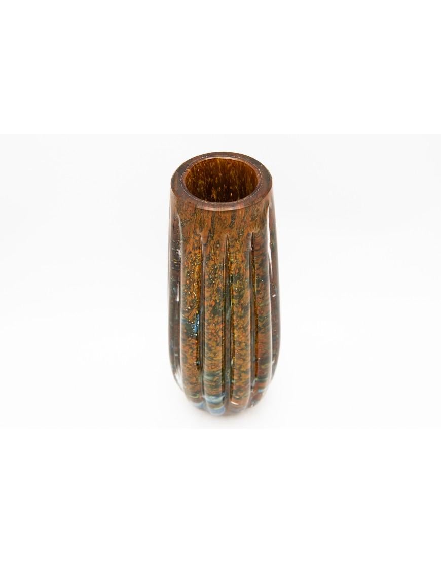 Glass vase, IKORA pattern, WMF, designed by Karl Wiedmann, circa 1930. Colorless, thick-walled glass, with air bubbles, embedded glass powder in orange, green and blue.

Height: 27,5 cm

Width: 7 cm