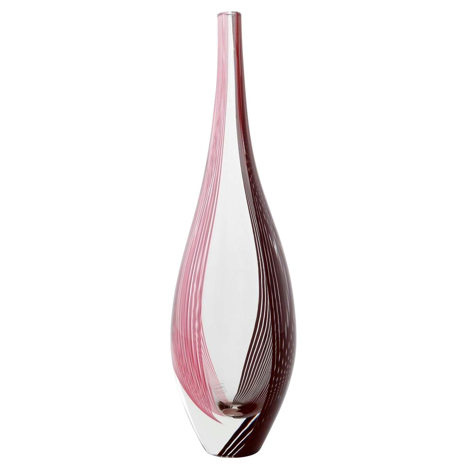 A beautiful Italian glass vase by Lino Tagliapietra for Effetre International, Murano, 1986.
Clear glass with pink, red, and purple strips.
The vase still has an Effetre International label on it.
It is also graven at the bottom with Lino