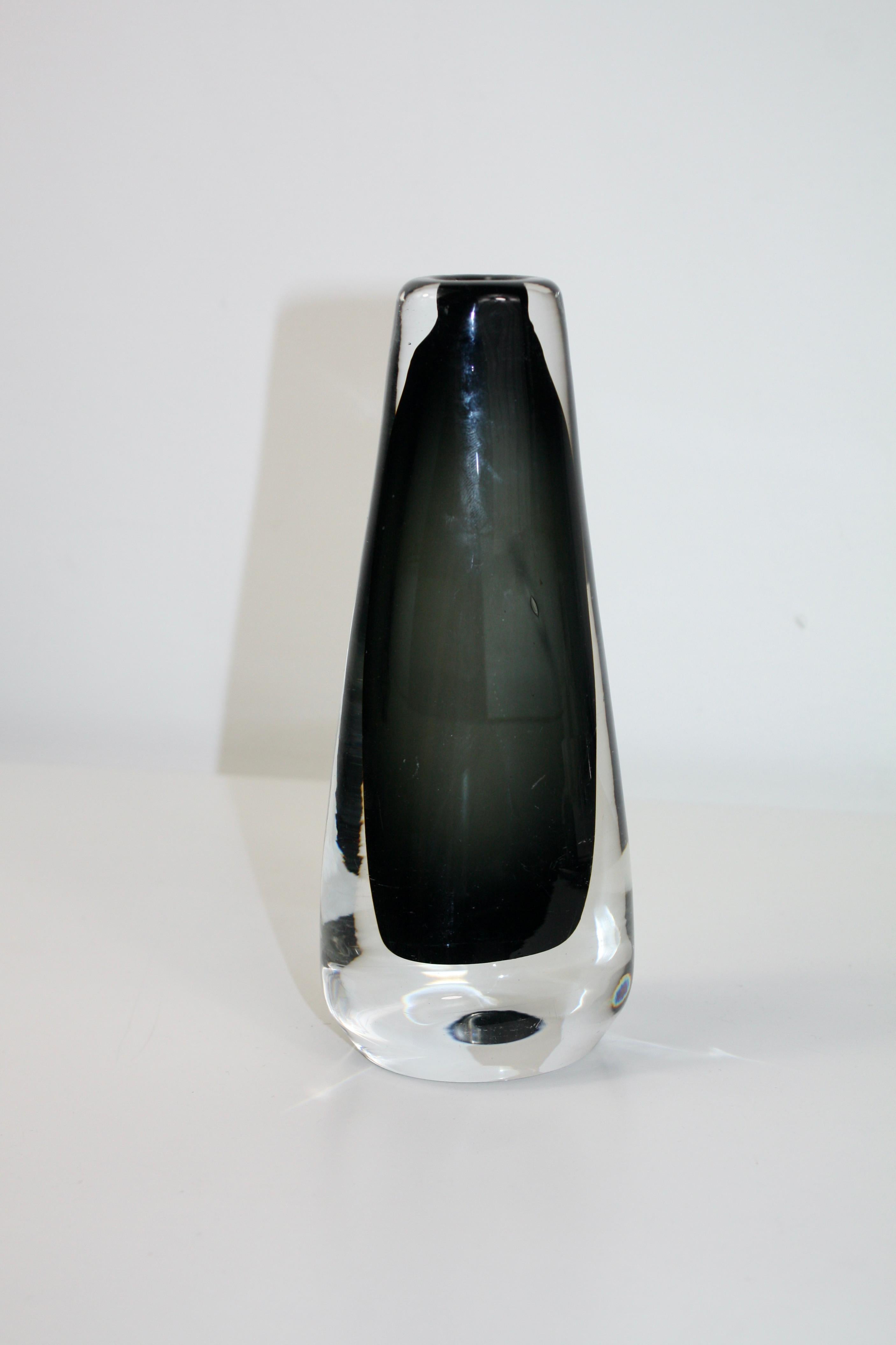 Beautiful glass vase designed by Nils Landberg for Orrefors, Sweden. 
The vase has a smoked dark grey colour wonderfully combined with clear glass. 
Perfect for a single flower or in a decorative still life.