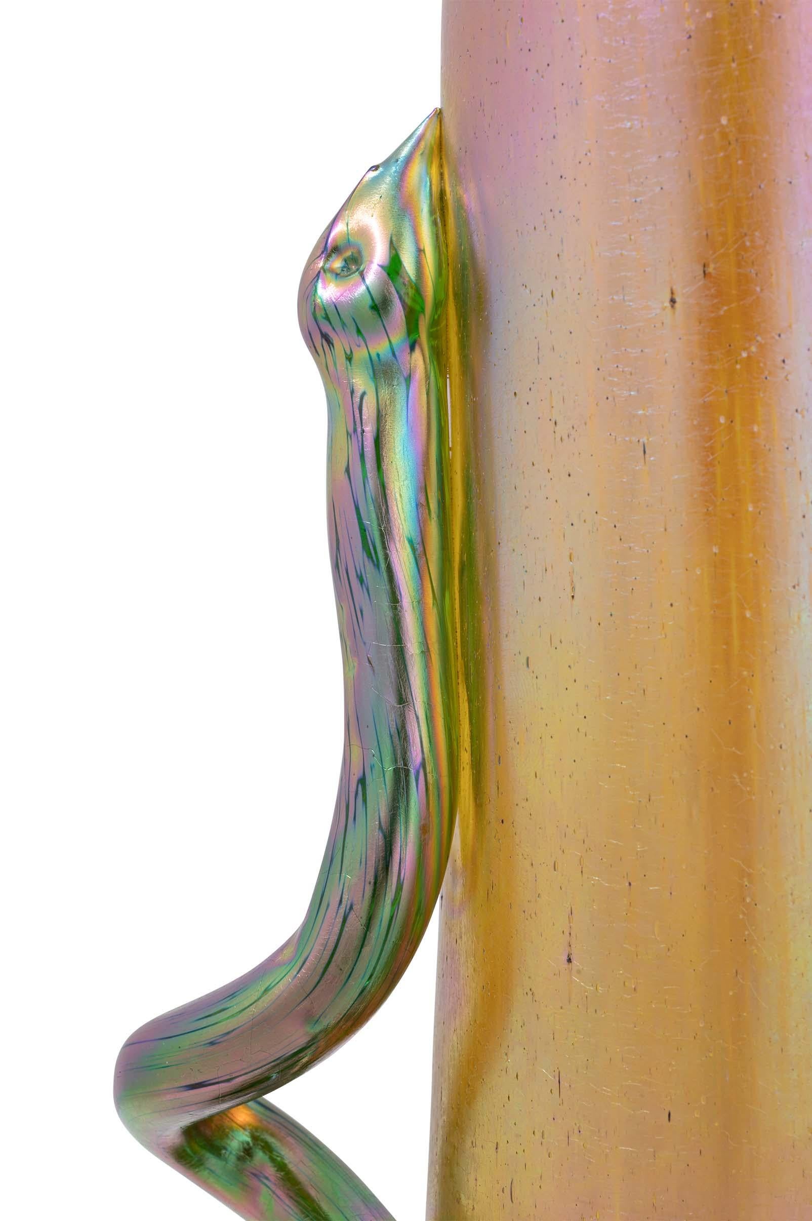 Tall glass vase with a snake application by Bohemian glassworks Johann Loetz Witwe, circa 1903, fully iridescent

With its wide variety of shapes and decorations, the Bohemian glass manufacturer Johann Loetz Witwe presented a particularly broad