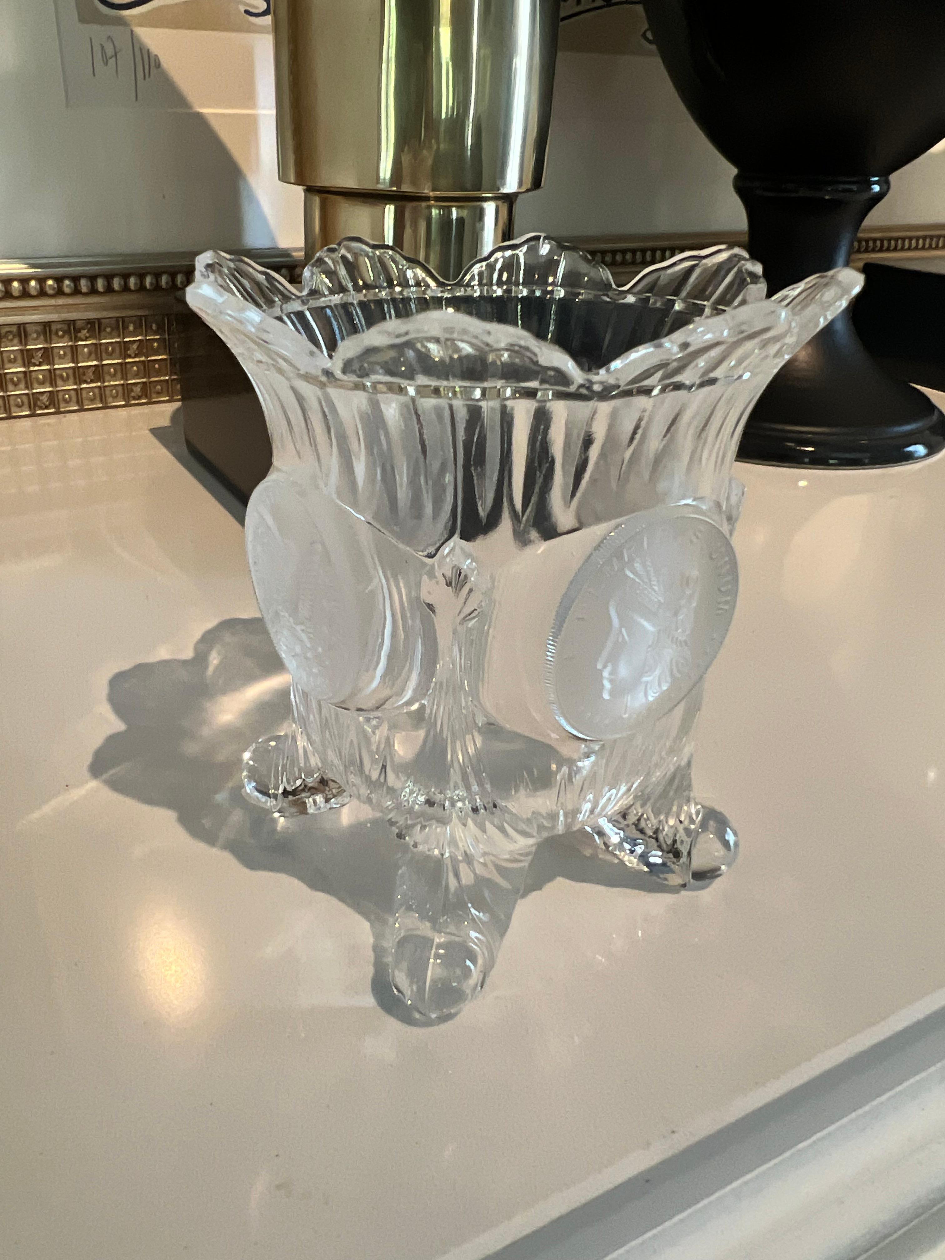 A unique vase - from shape to having legs and the special Medallions surrounding the piece.

The Medallions are the front and back of Coins - an interesting scallop top with four curled legs... the piece works for well as a place holder for a