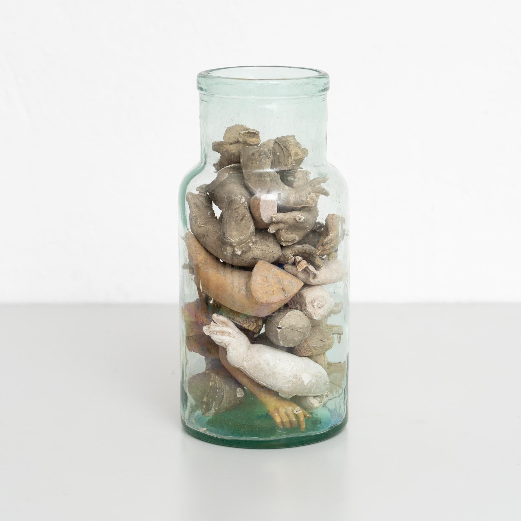 Glass Vase with Sculptural Objects – Unique and Mysterious Design

This stunning glass vase contains a captivating arrangement of sculptural objects resembling anatomical fragments, such as hands and arms, carefully positioned inside. Its intriguing