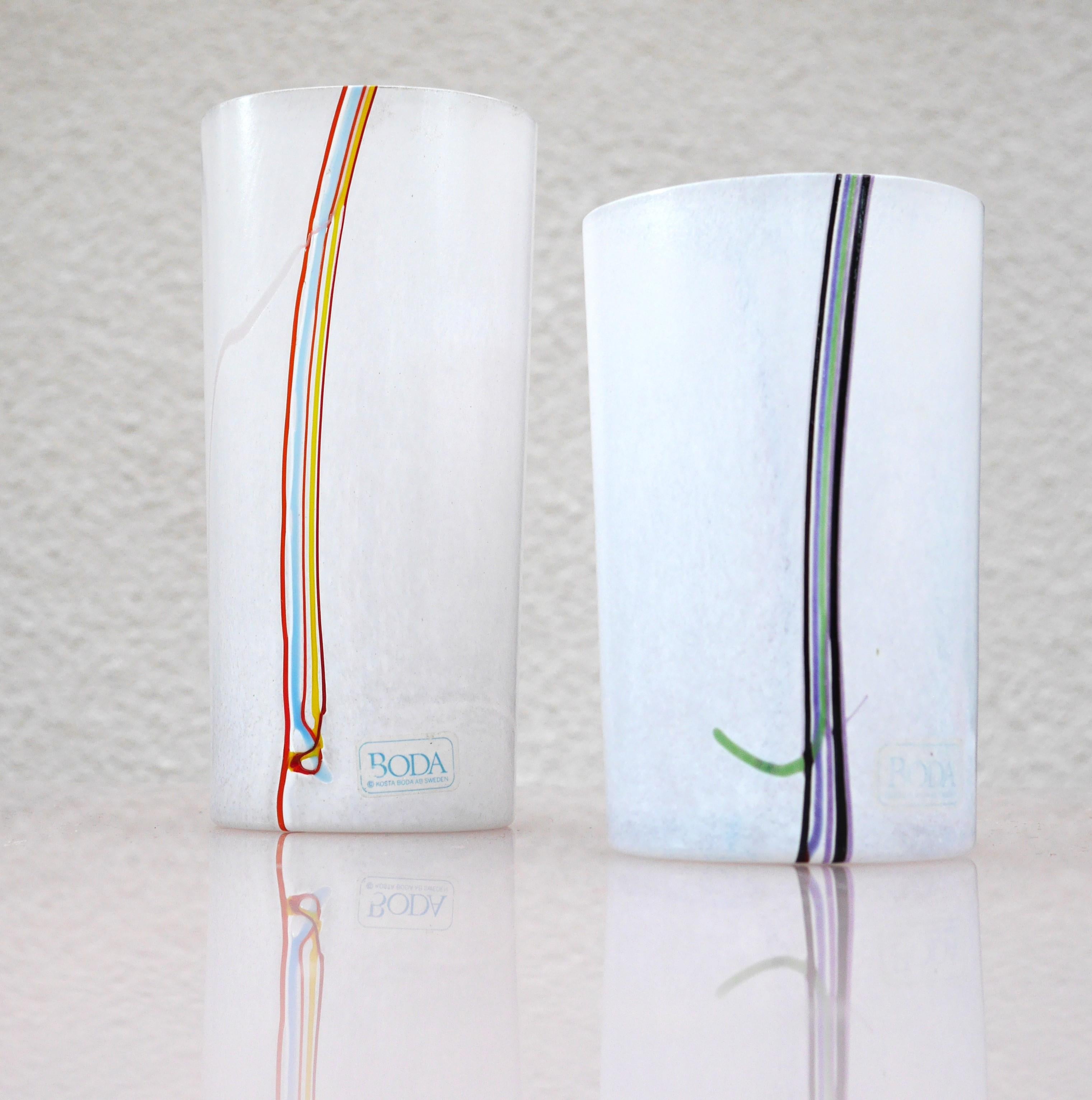 A fantastic pair of glass vases handmade and signed by talented Bertil Vallien for Kosta Boda, Sweden. These vases are simple but so beautiful, simple yet very sophisticated and they will be an eye-catching centerpiece. They are in perfect