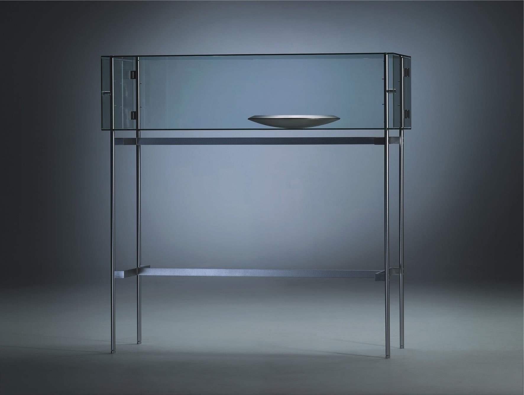Glass Visibile G Horizontal Standing Cabinet by Angelo Alinea
Dimensions: W 120 x D 120 x H 45 cm 
Material: tempered glass, 6 mm. Door: tempered glass, 4 mm , with lock frame: silver lacquered metal.
Visibile horizontal standing.

This display case