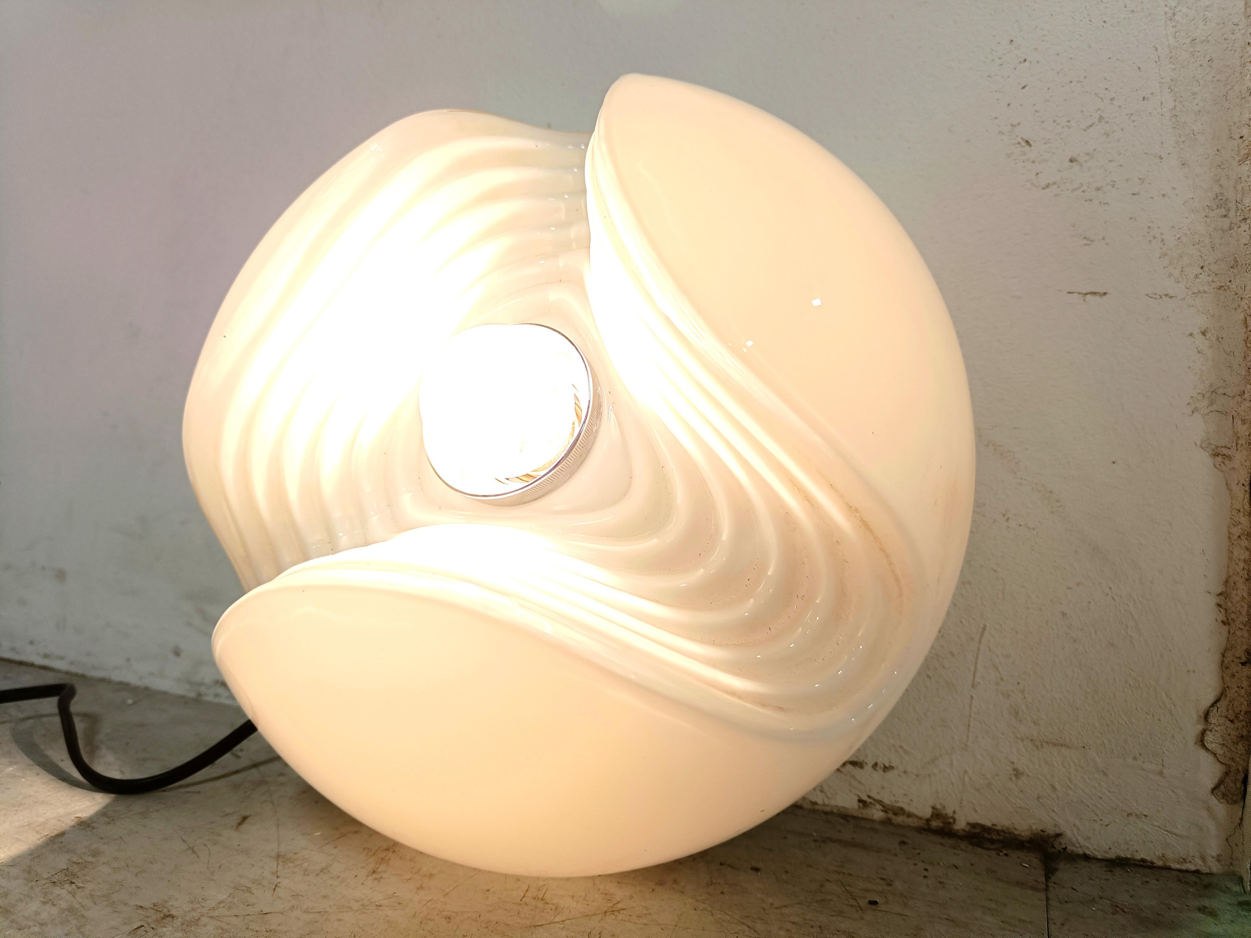 Vintage glass wall light or table lamp by Peil and Putzler.

The lamp emits a beautiful diverted light thanks to its carefully designed glass.

Works with a regular E26/E27 light bulb, US compatible.

1980s - Germany

Dimensions:
Height: