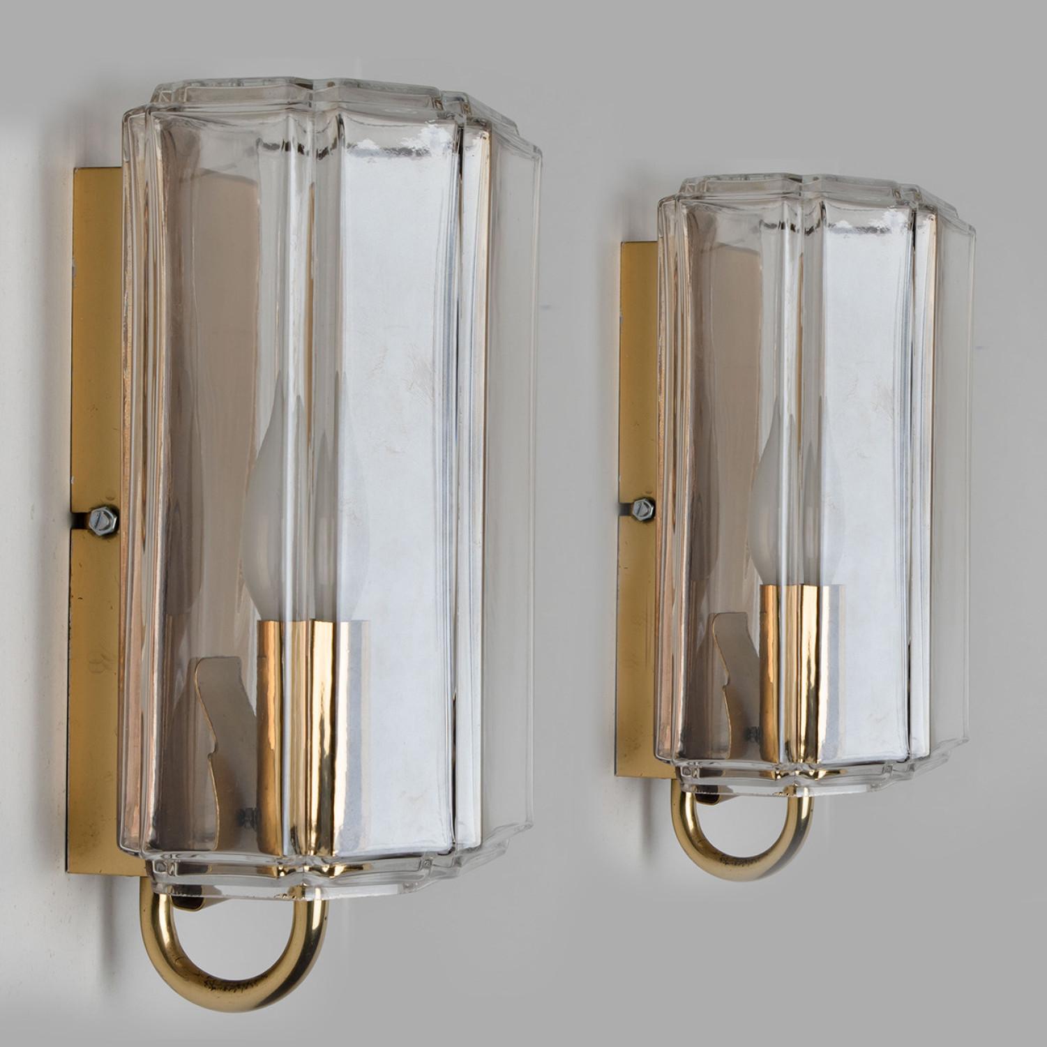 This beautiful set of hand blown glass wall lights were manufactured by Glashütte Limburg in Germany during the 1960s (late 1960s-early 1970s). Beautiful craftsmanship. These midcentury vintage lights feature handmade, elaborate lightly smoked glass