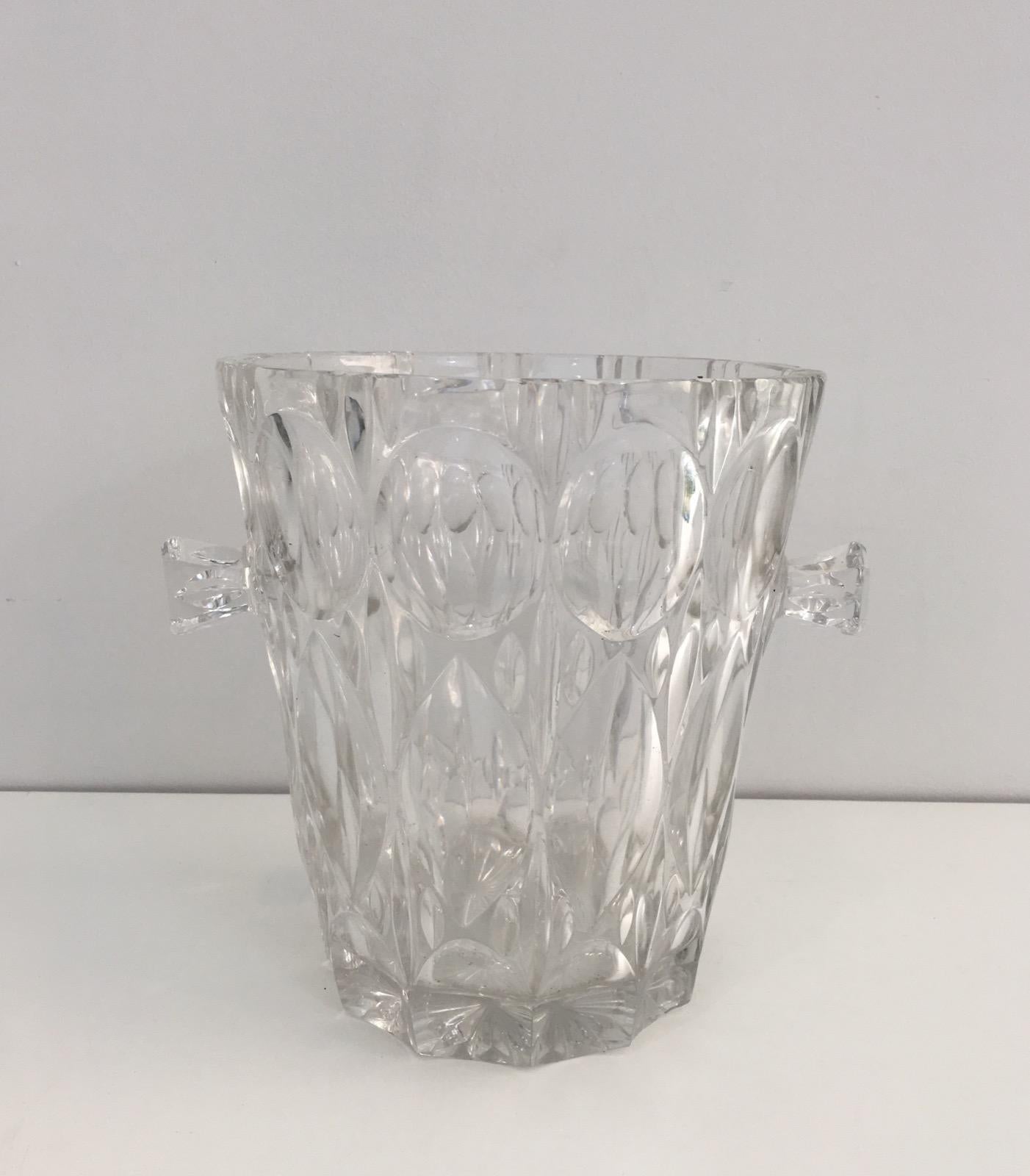This wine or champagne ice bucket is made of crystal. This is a French work, circa 1970.