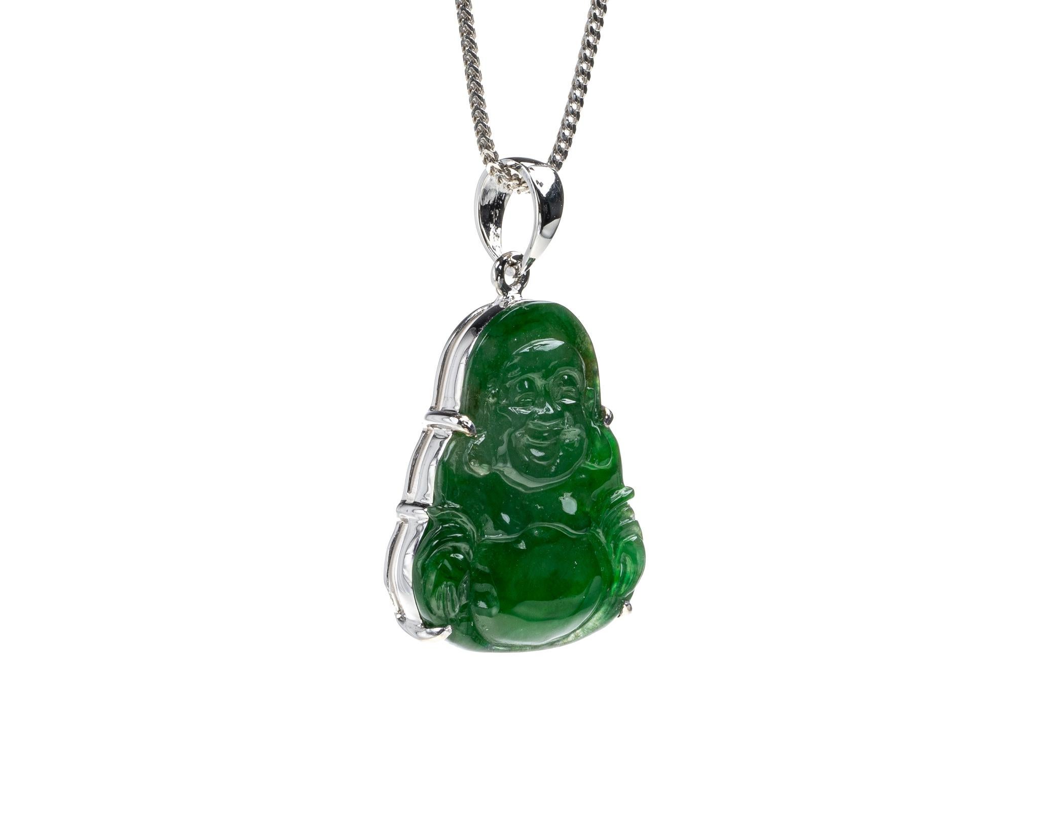 This is an all natural, untreated glassy green jadeite jade carved happy buddha and set on an 18K white gold bail.  The carved happy buddha symbolizes happiness, compassion and protection.    

It measures 0.70 inches (17.9 mm) x 0.84 inches (21.5