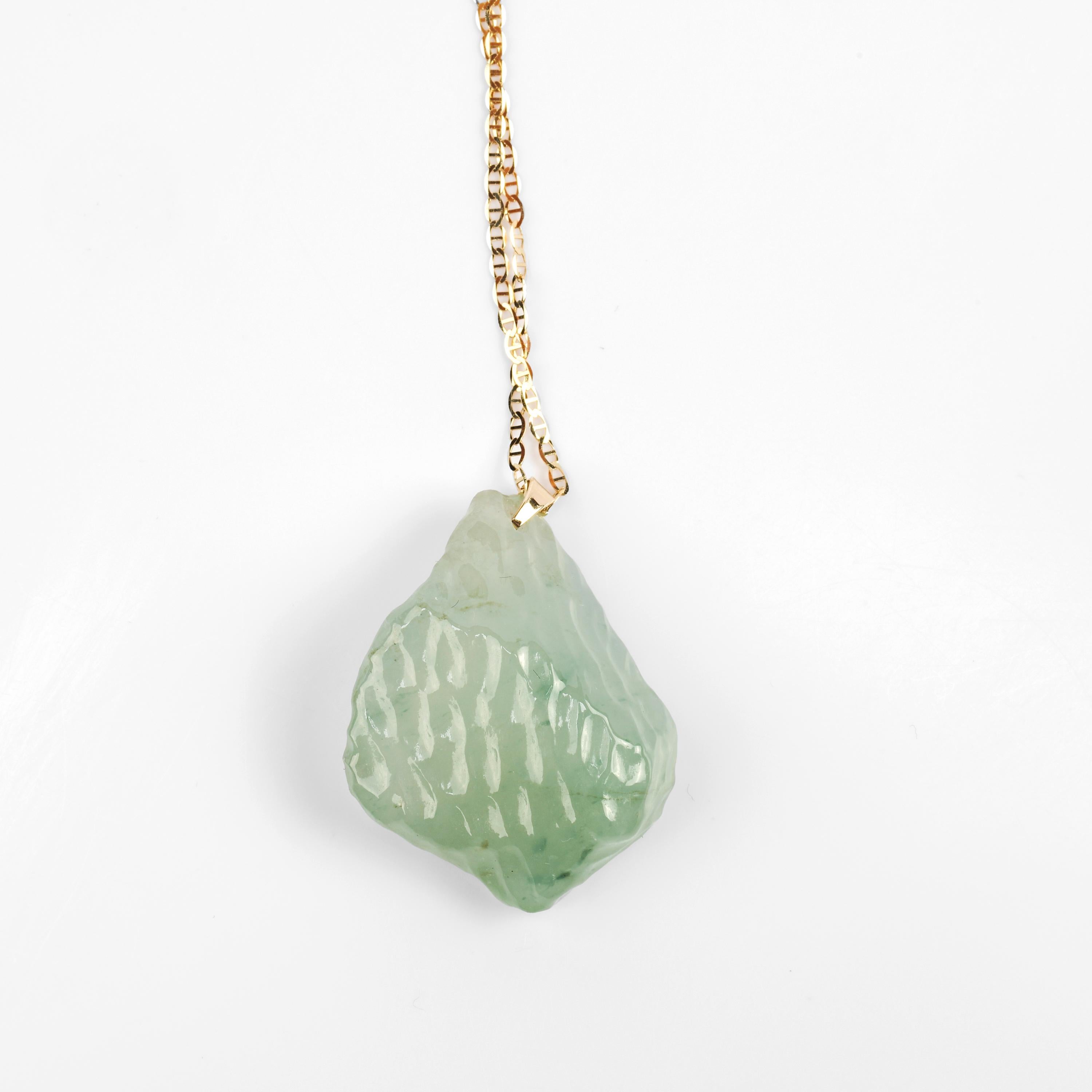 This glassy light green jade pendant has been carved free-form style and as a result, is a Rorschach test you can wear around your neck every day. Do you see a raw diamond or a chunk of glacier ice? An exotic juicy fruit from another world or a