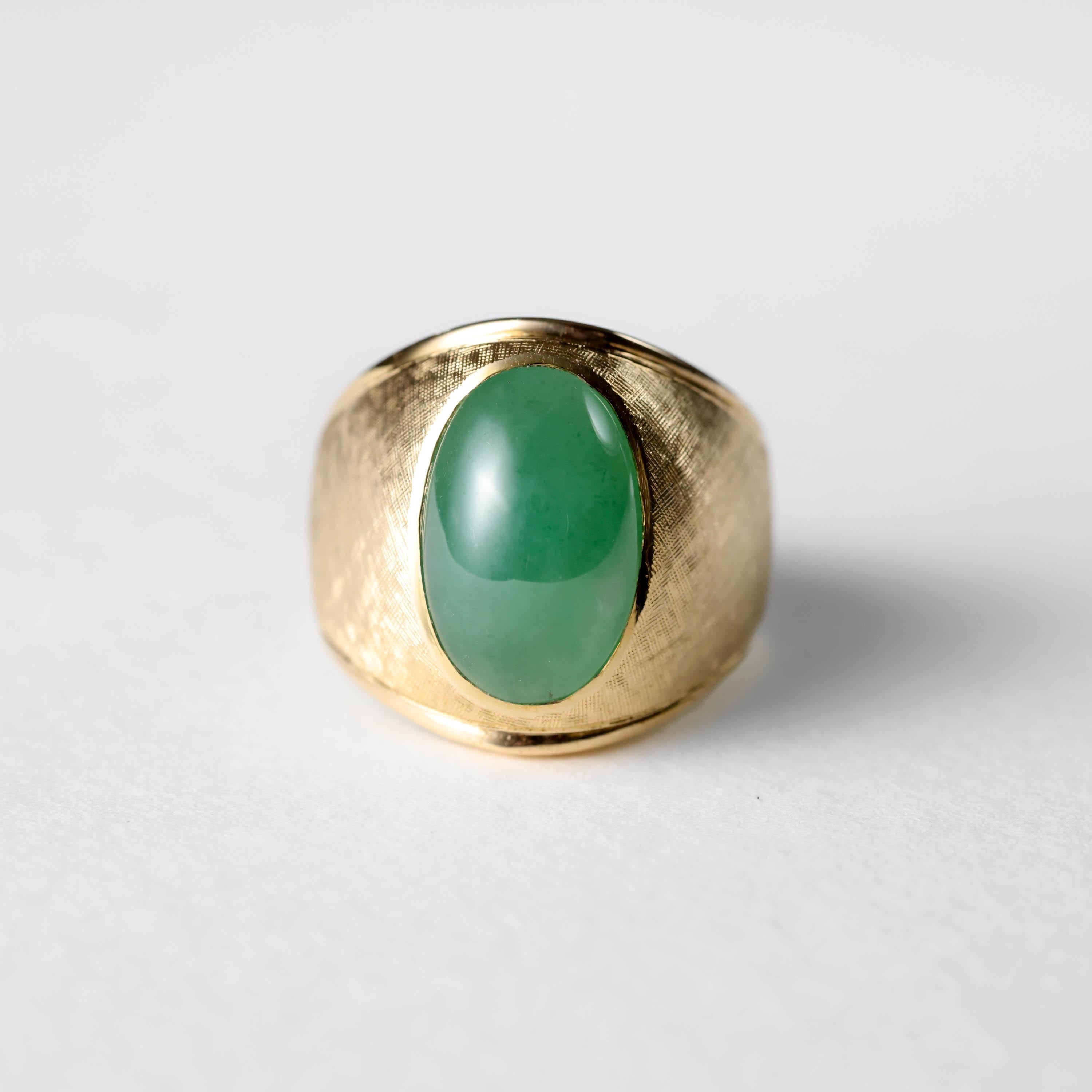 This men's jadeite jade ring represents old-school class: hand-fabricated in America in the 1960s, hand-crafted to perfection. 

It features a large double cabochon of highly translucent untreated Burmese jadeite jade bezel set into a spectacular