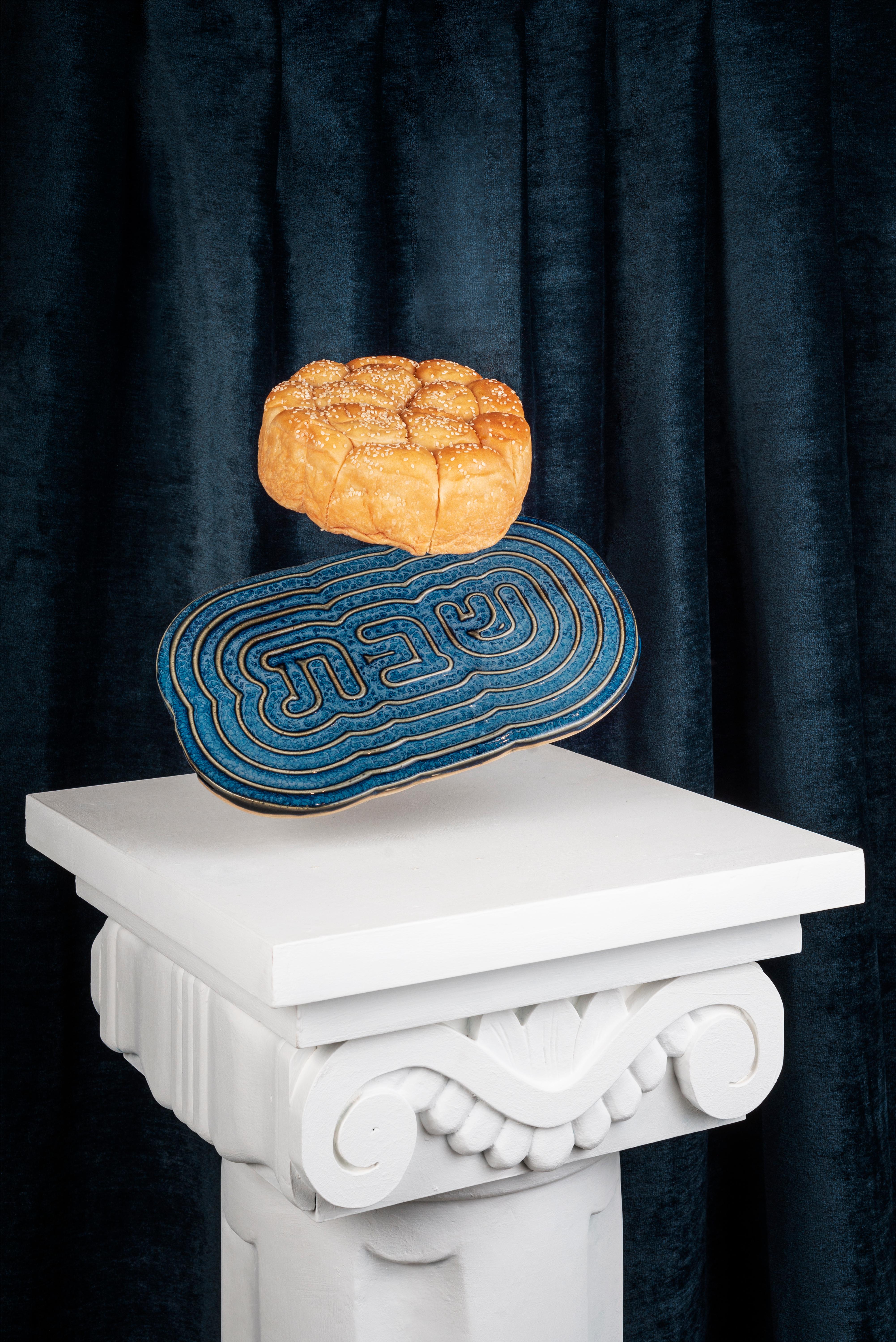 Introducing a masterpiece of Judaic artistry, the Bruci Shabbat Tray is a true testament to the essence of Shabbat. Embodying the timeless Jewish values of creation and light, this exquisite ceramic tray is the perfect way to bring sanctity to your