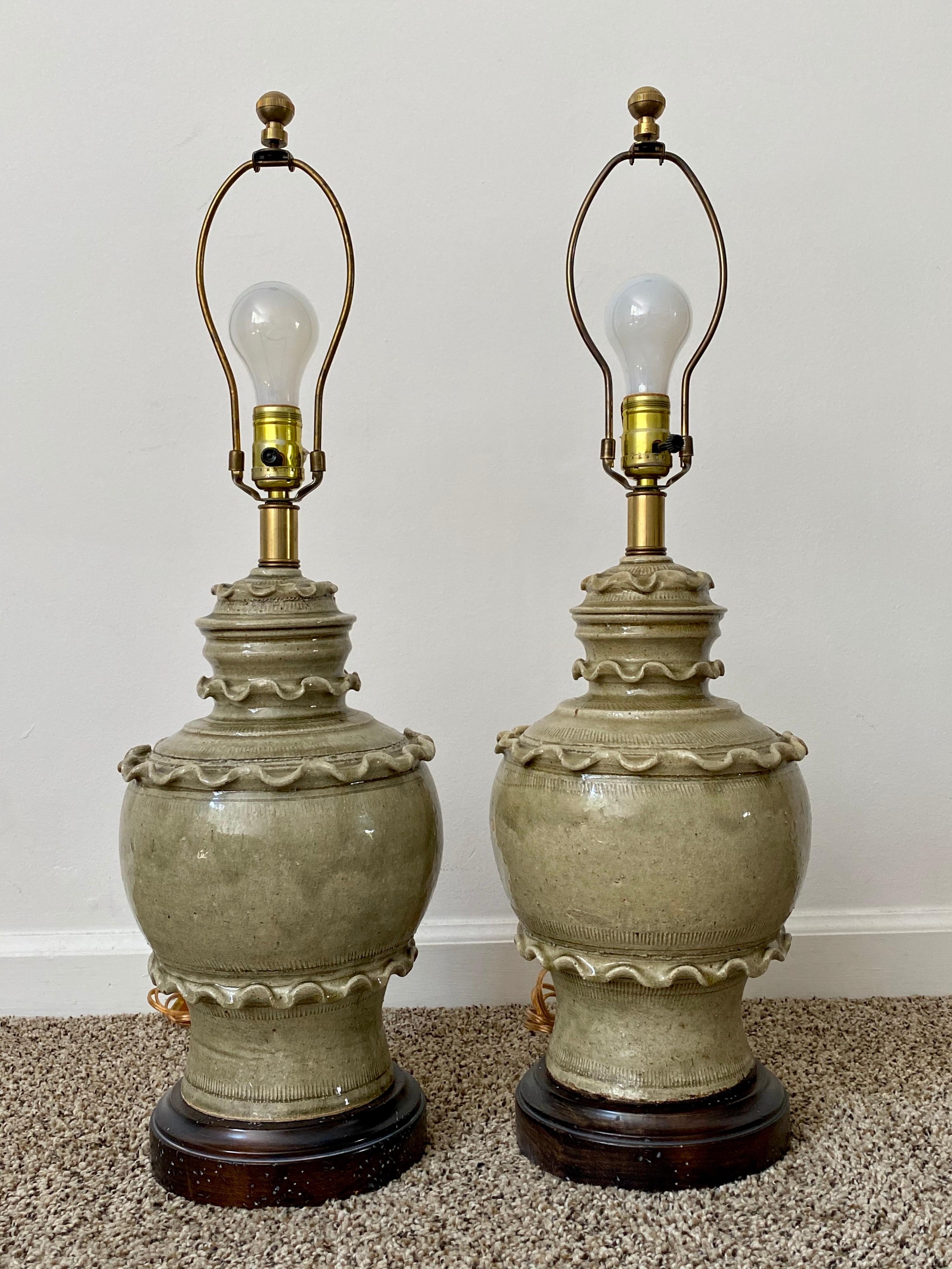 Pair of glazed celadon ceramic lamps by Frederick Cooper. Very little wear by age. Overall height 28”, height to the top of the ceramic body 16”. Shades not included.