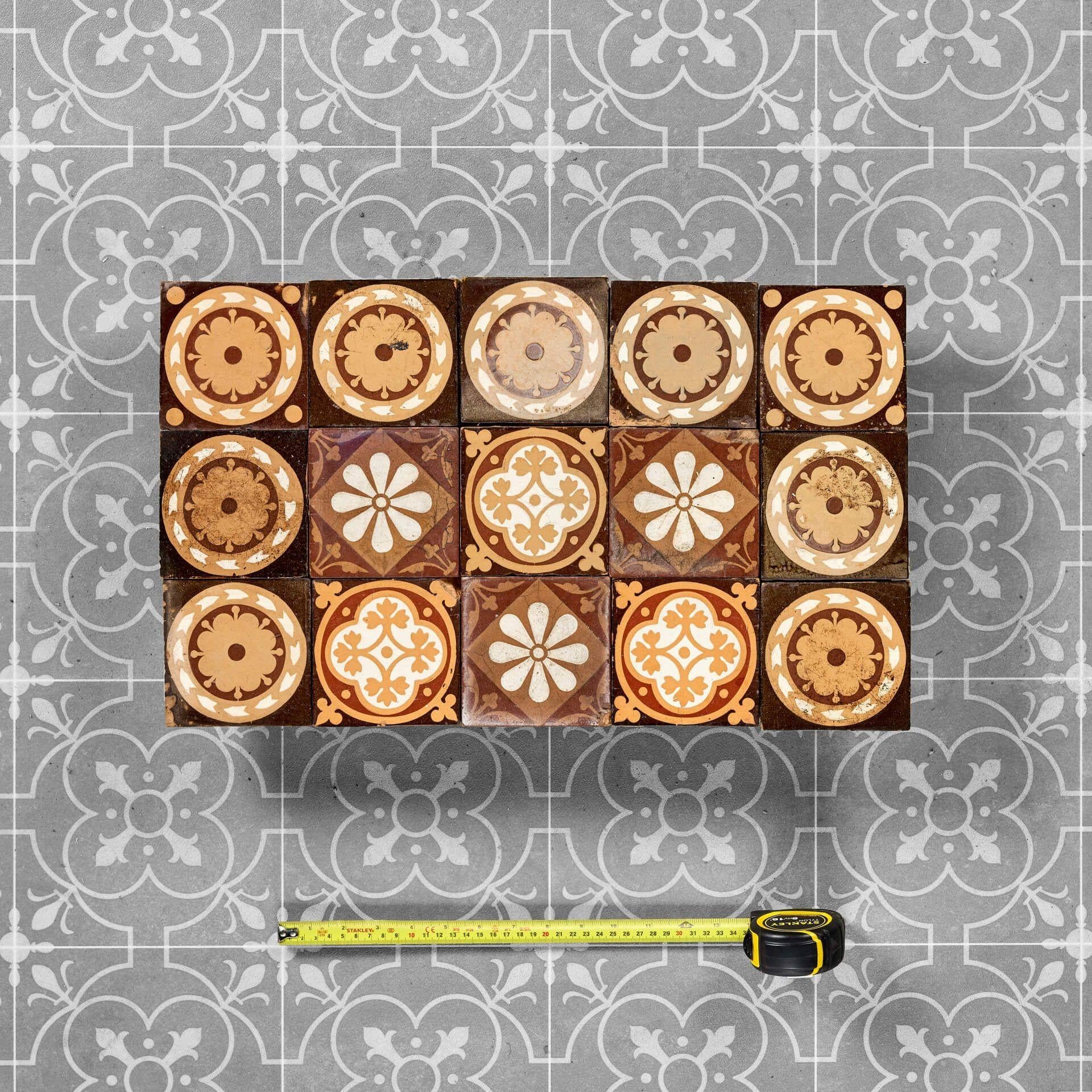 A small set of 15 brown glazed ceramic 10.5cm square tiles, perfect for use as an antique tile backsplash in a period cottage or Victorian kitchen. Dating from the late 19th century, these antique tiles are decorated with floral themes, bringing a