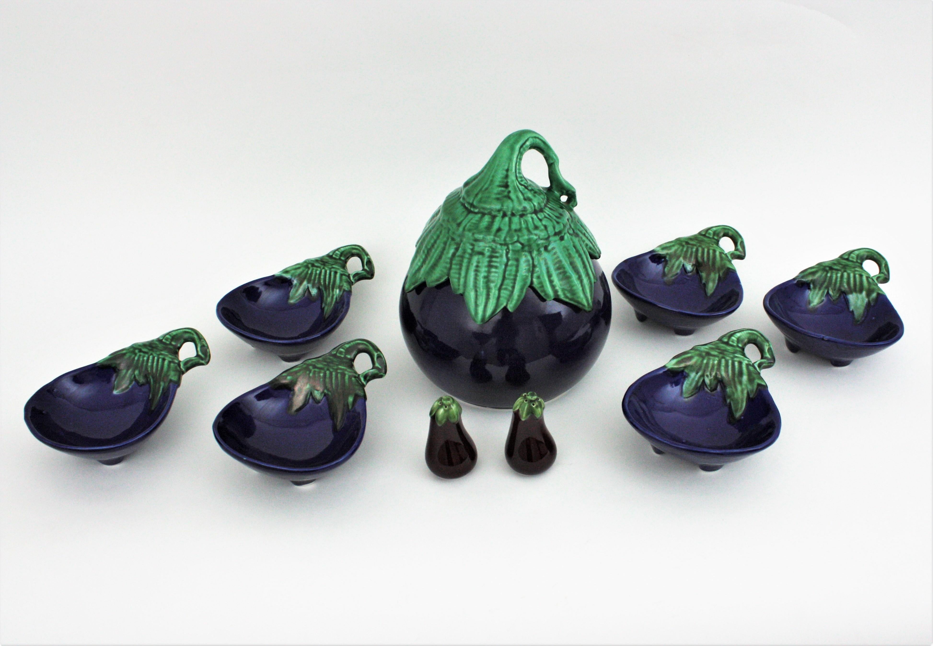 Tableware serving set eggplant design. Italy, 1960s.
One of a kind majolica ceramic tableware set of pieces. The set is comprised by:
1 large eggplant tureen centerpiece
6 aubergine glazed ceramic appetizer or snacks bowls or dishes
2 pepper and
