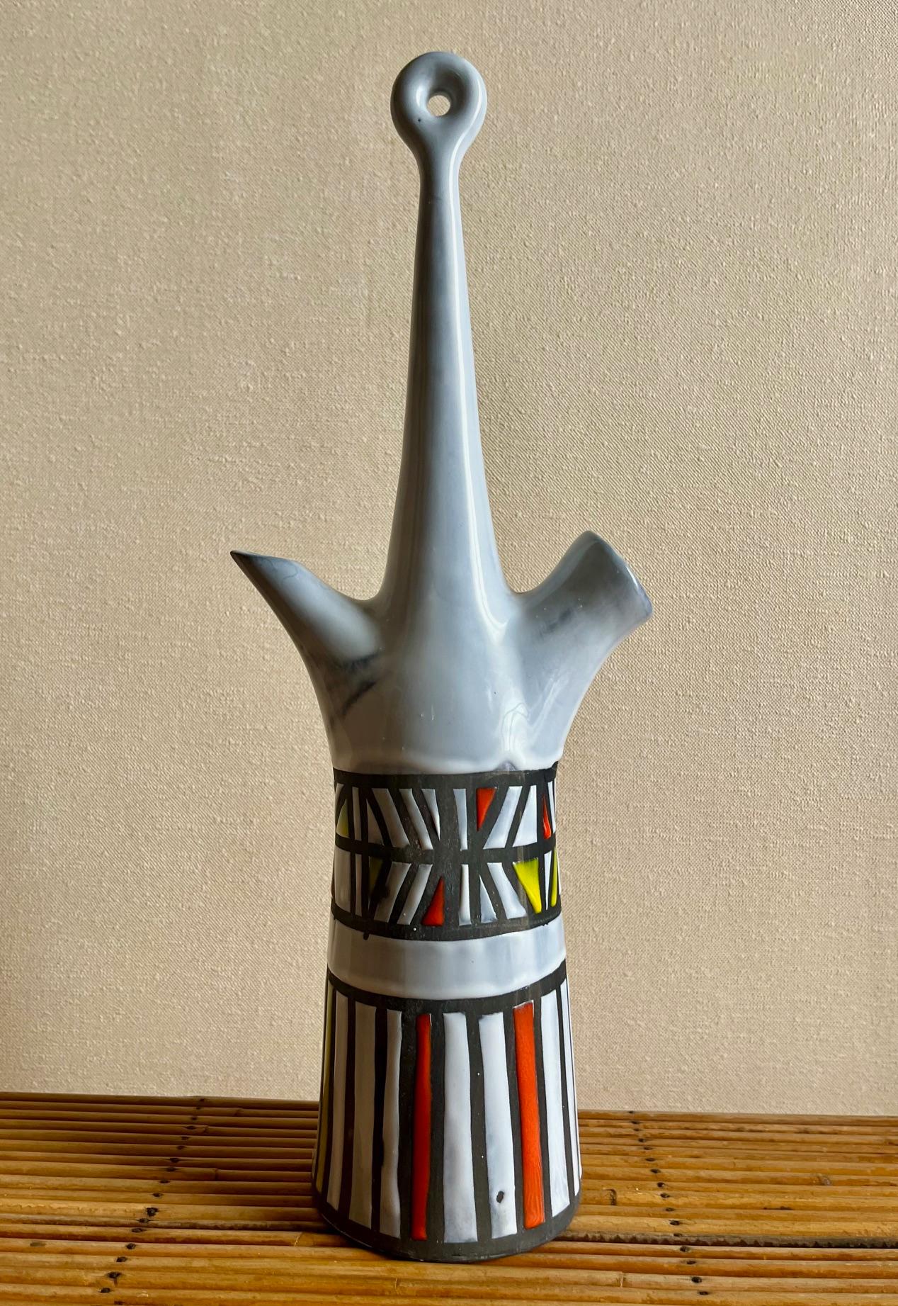 Long neck ceramic bottle or flask.
White glazed ceramic with geometrical red, yellow and black linear decoration.
For this shape, this is a rare example of an 