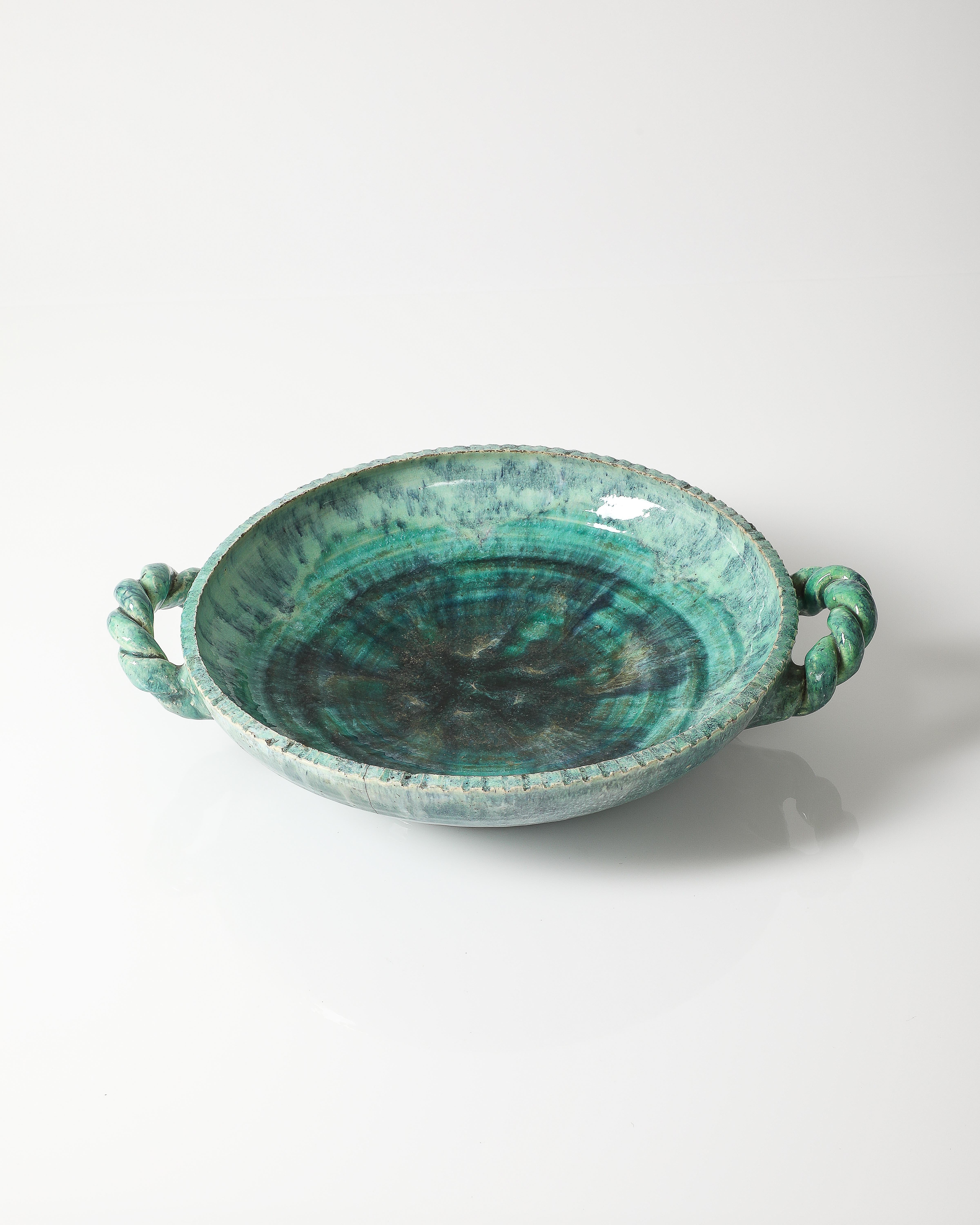 Blue glazed ceramic bowl with unique handles.