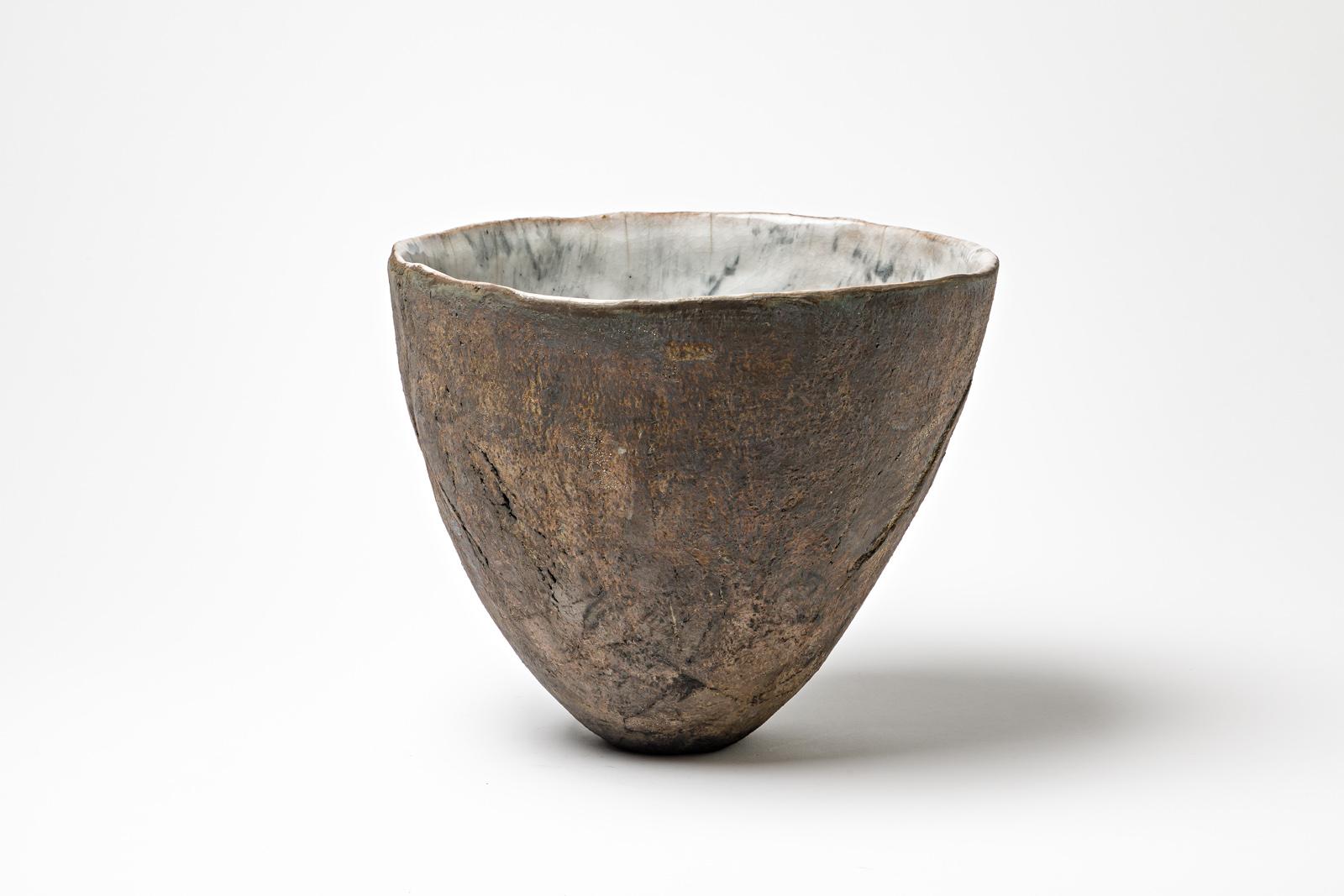 Glazed ceramic bowl with pearly white interior by Gisèle Buthod Garçon. 
Raku fired. Artist monogram and signature under the base. Circa 1980-1990. 
H : 8.3’ x 9.8’ inches.