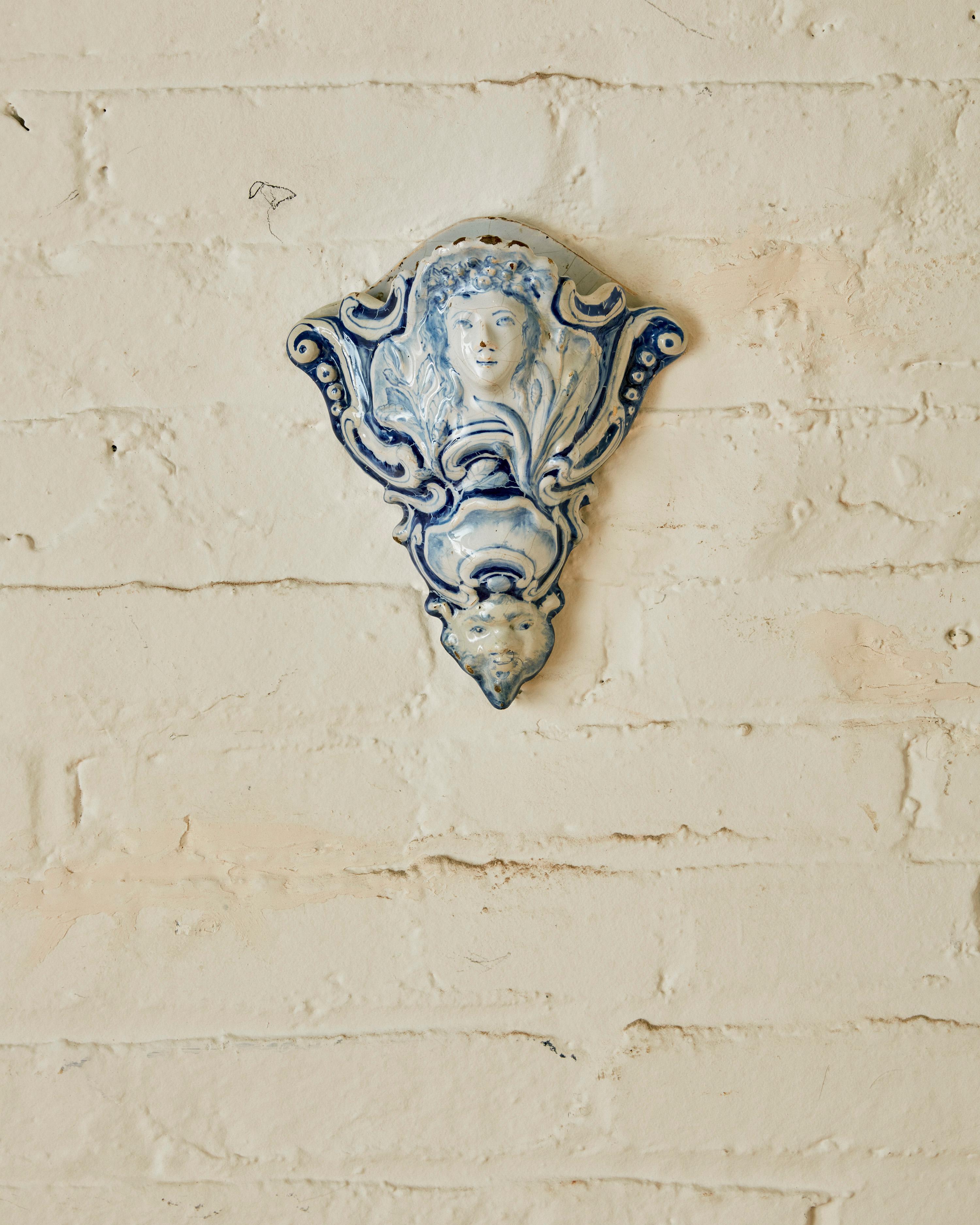 Blue and White Glazed Ceramic Delft Wall Pocket, depicting a floral mask on the top half and another on the bottom half.

