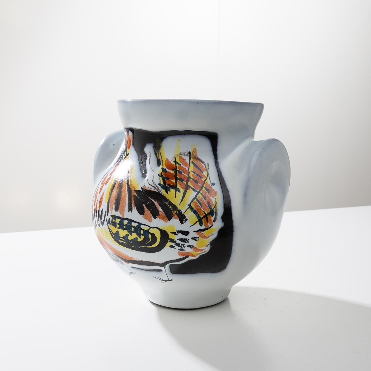 Very beautiful and rare vase (so-called ears model) by Roger Capron in white glazed ceramic with a rooster decoration made entirely by hand. The drawing of different colors, orange red, yellow and black on the white background.
Probably made around