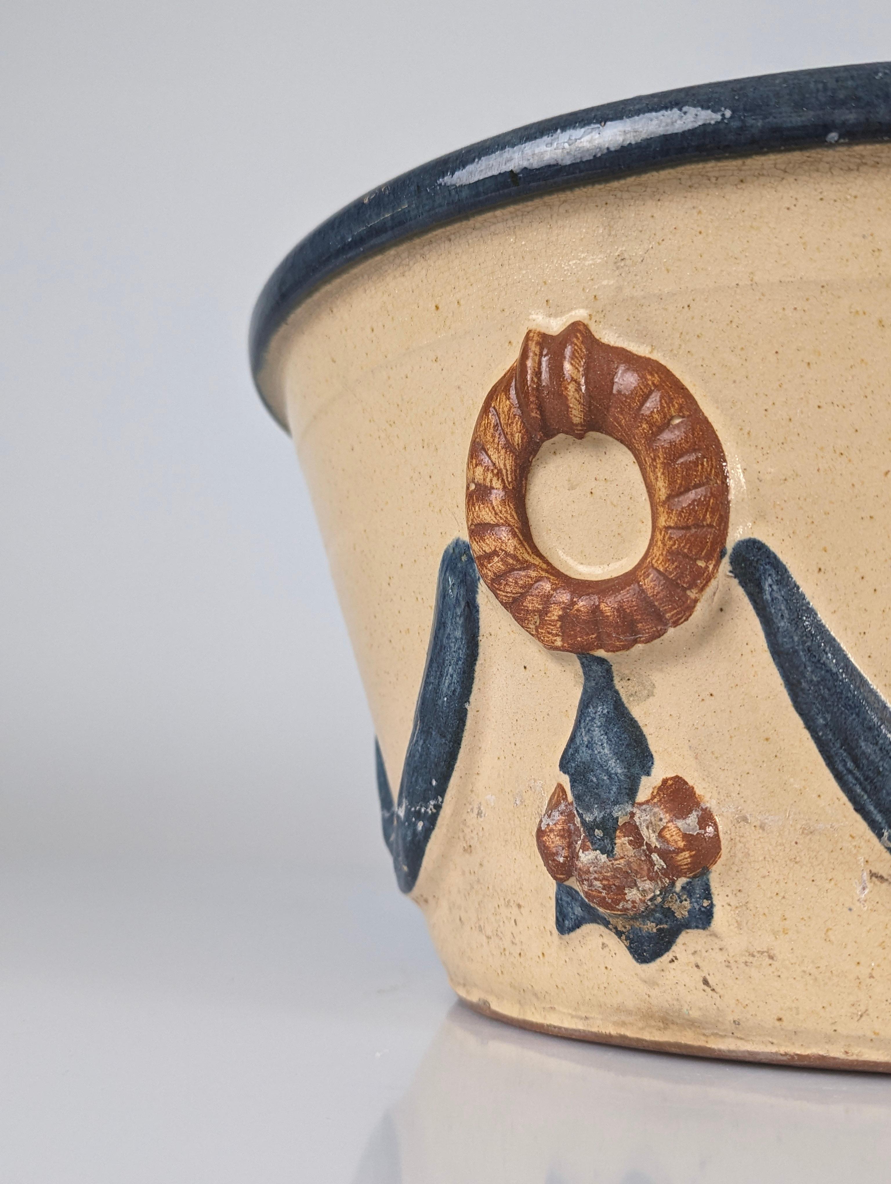 This original mid-century Malagueña ceramic flowerpot with blue accents, created by the renowned Cerámica Hermanos Morillo, is a standout example of traditional Málaga craftsmanship. Founded in 1941 by José Morillo, the creator of this type of