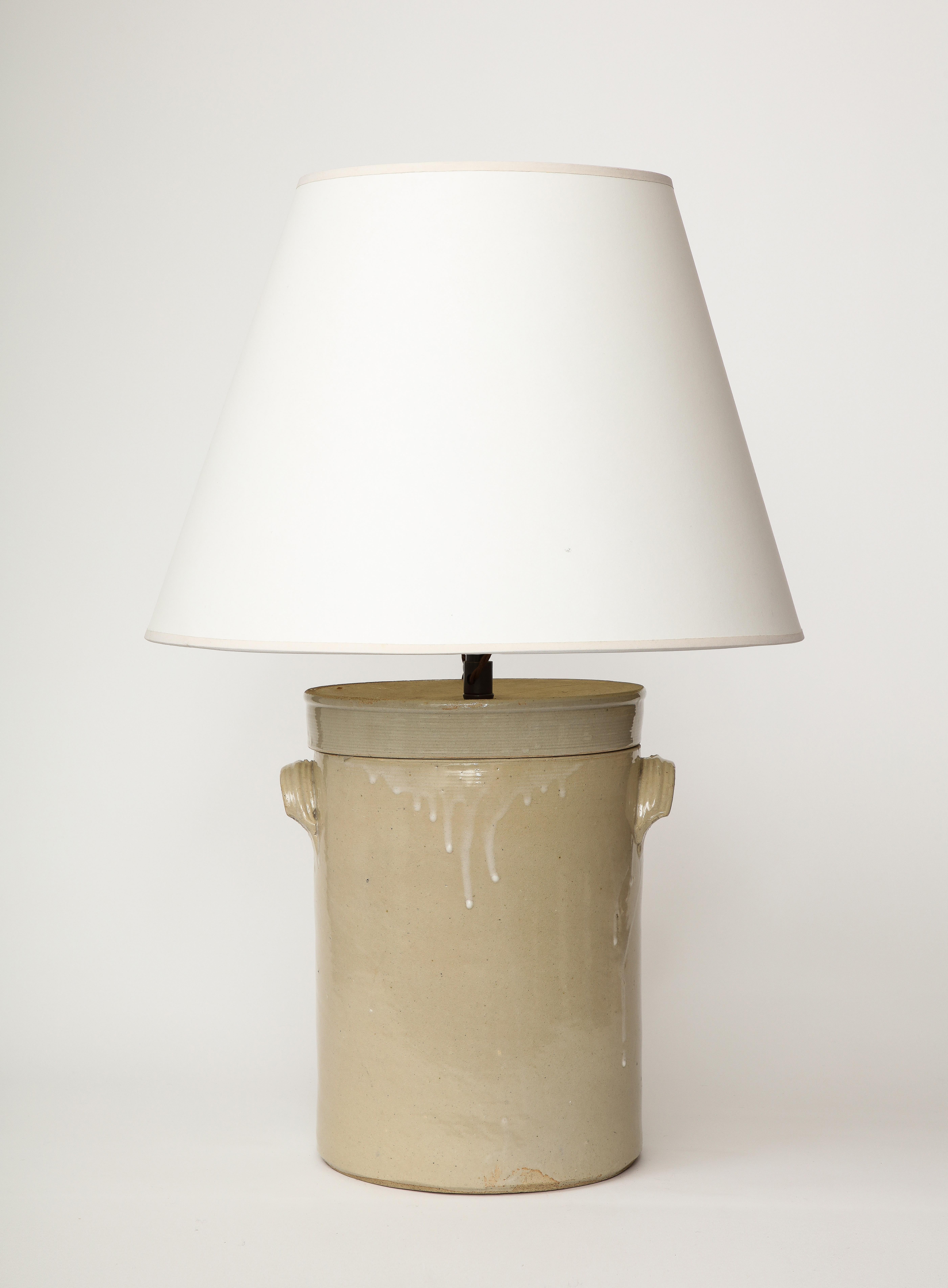 Unique, handmade table lamp, crafted from a 19th Century glazed ceramic butter churn.

This table lamp was recently rewired with a black twisted silk cord, bronze hardware, a dimmer at the neck, and an adjustable shade harp.

Overall Height: