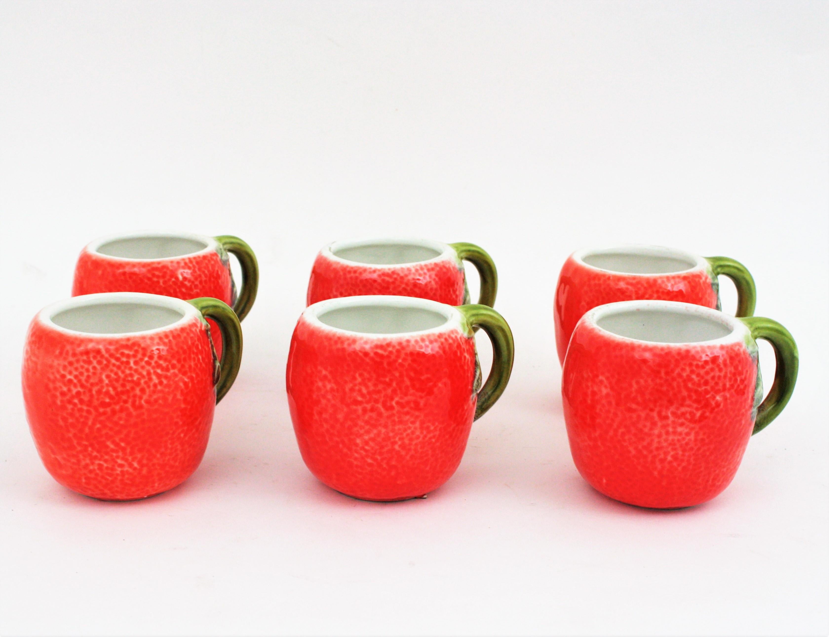 Coffee or tea set of cups orange design, Spain, 1960s.
Cool set of hand-painted orange glazed ceramic cups. 
Manufactured at the Mid-Century Modern Period.
This set will be a nice accent for your kitchen or table to enjoy parties and