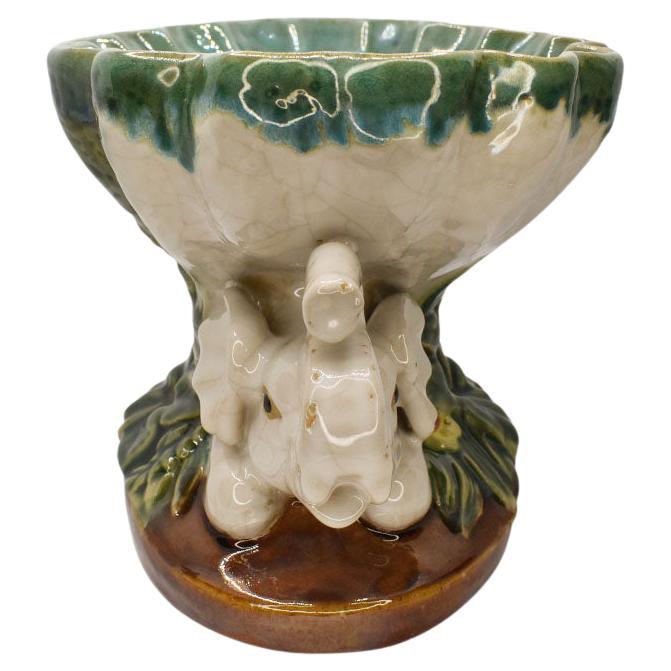 This beautiful polychrome majolica key dish will be the perfect addition to a foyer table, coffee table, or nightstand. It is very heavy for its size and created from ceramic. Each side features creamy white elephants with their trunks up.
