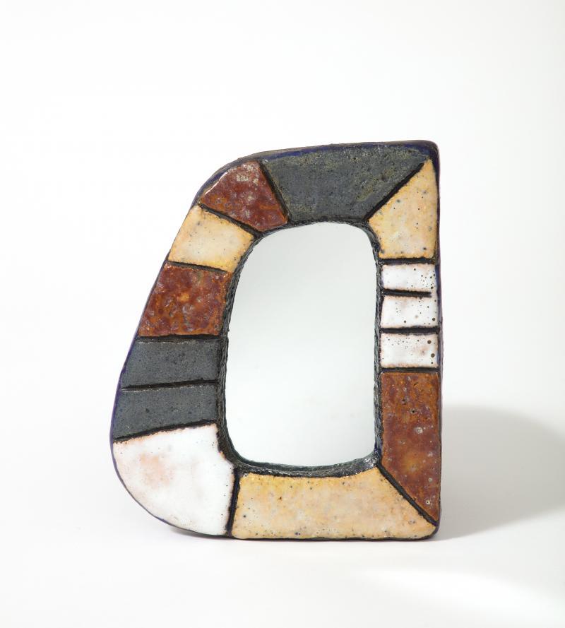 Rare enameled ceramic mirror by Les Argonautes, Vallauris, France, c. 1960. Les Argonautes studio was created by Isabelle Ferlay and Frederique Bourguet in Vallauris, France during 1953-1997. This mirror has been signed on the back of the frame with