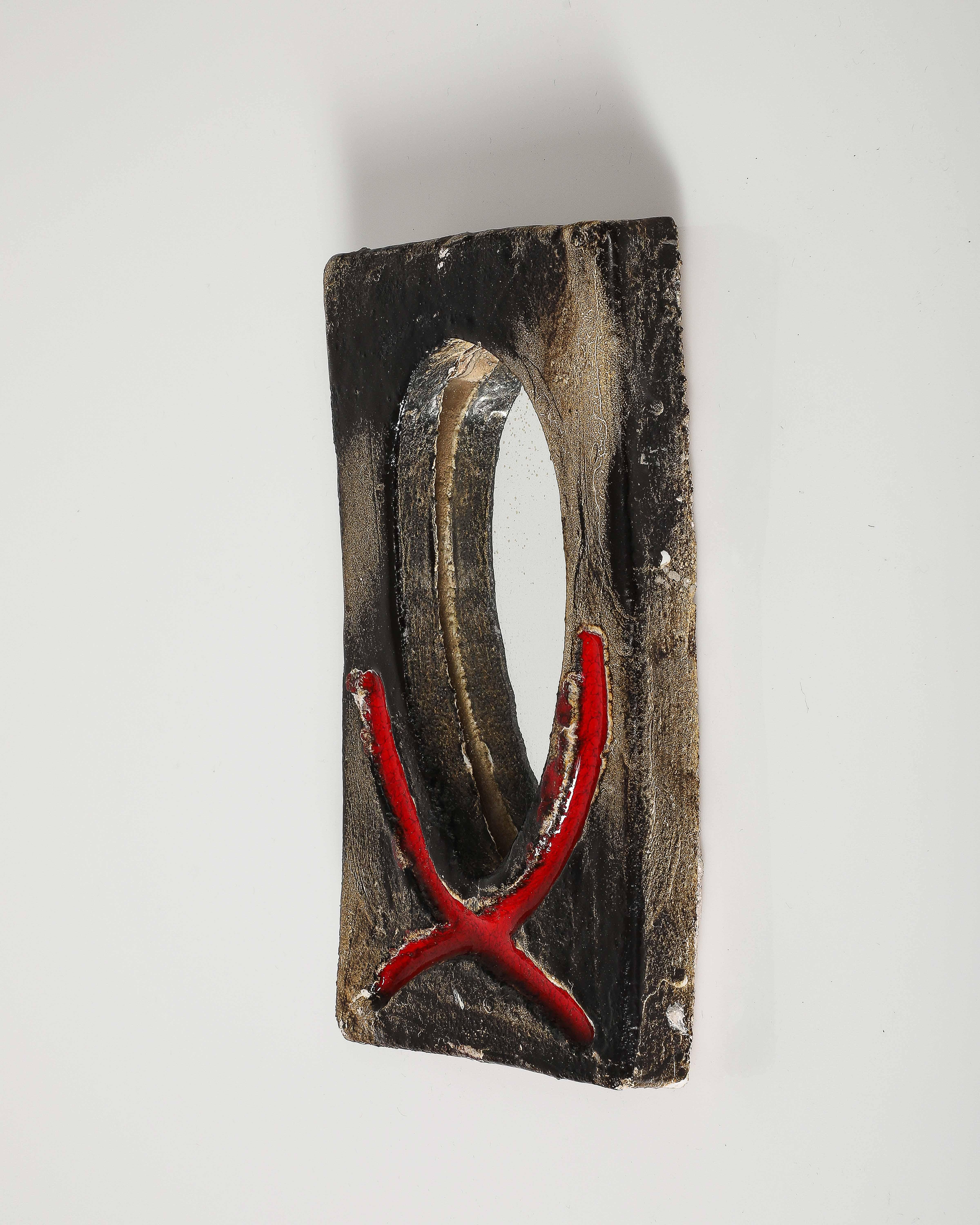 Small glazed ceramic wall mirror.