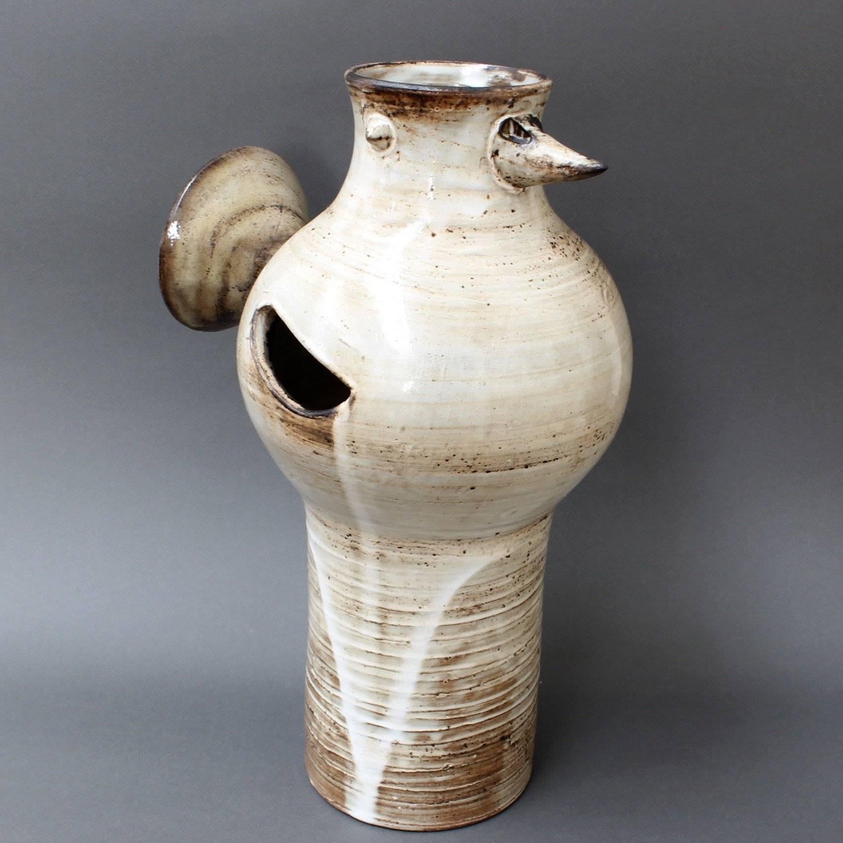 Glazed ceramic, stylised bird vase, circa 1960s by Jacques Pouchain (1925-2005). This is a tall, sculpted, ceramic vase in Pouchain's inimitable style. The rounded base is decorated with circular, ascending lines and a drip glaze which emanates from