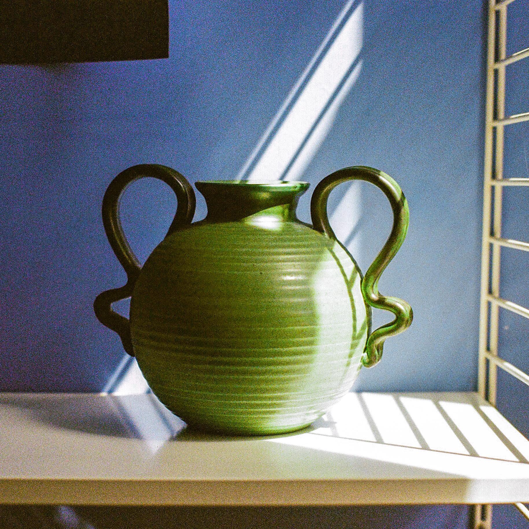 Glazed Ceramic Vase with Two Handles by Eva Jancke Björk for Upsala Ekeby, Sweden, c, 1940

This vase is an excellent example of Eva Jancke Björk’s work. Lovely saturated sage color with contrasting dark green arms and rim.

Materials: Glazed