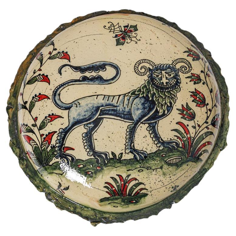Glazed earthenware medaillon, with fantastical animals by Jérôme Galvin.