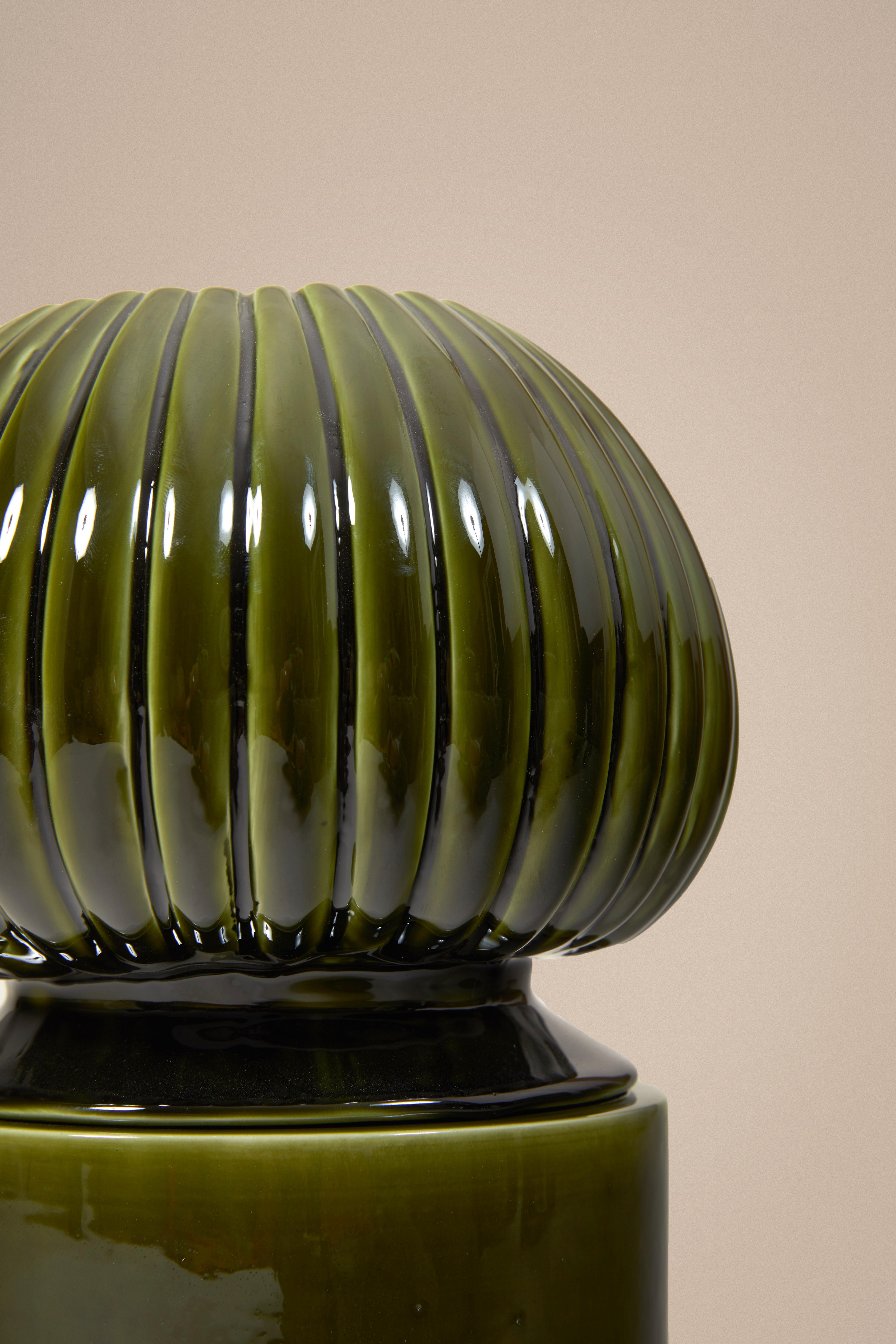Sculptural candle holder inspired by organic shapes, available in green, purple, blue and matt white colors, and two sizes. Made by a Parisian ceramic workshop.