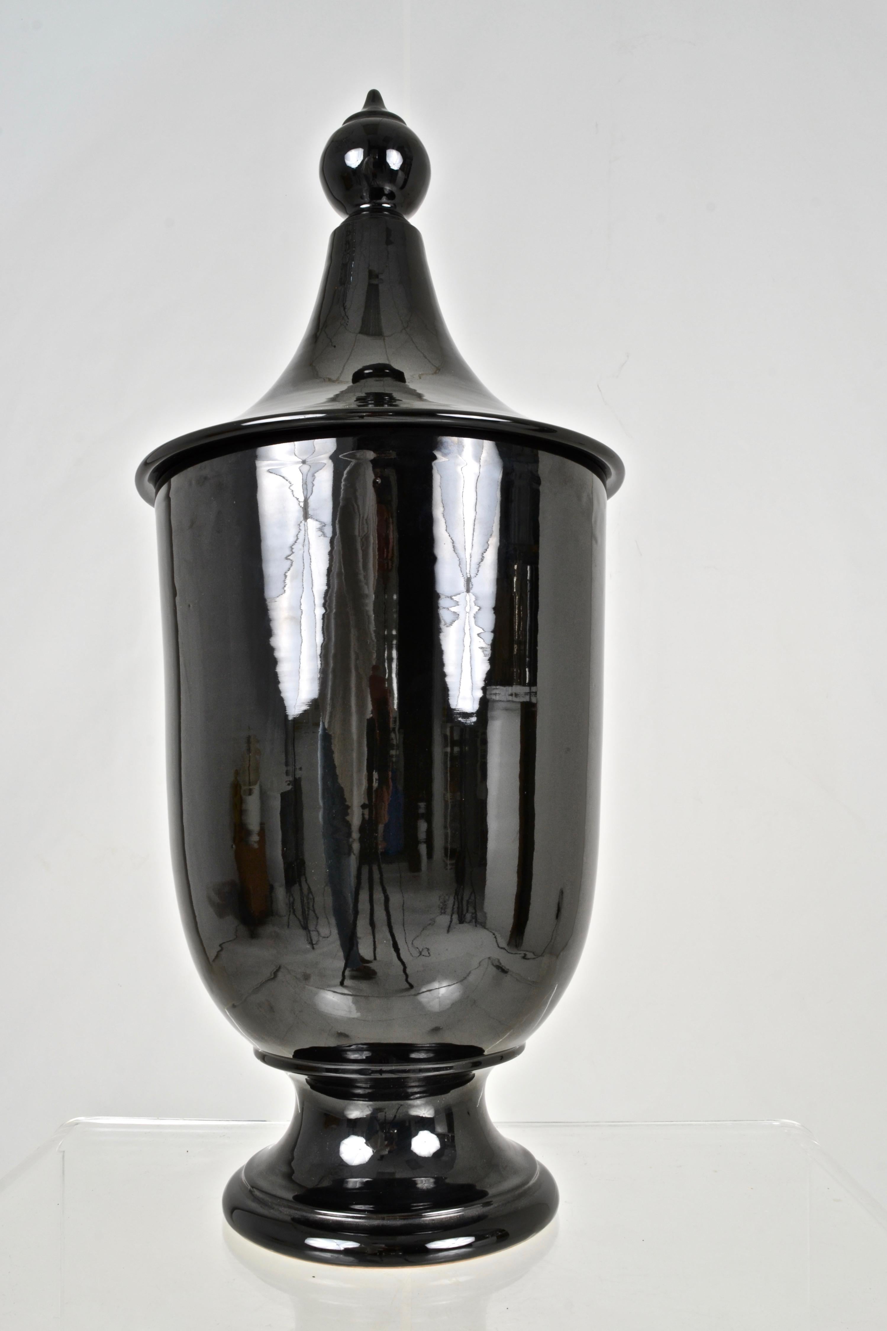 Wonderful presence on this lidded urn. High gloss black glaze and good size: 29 inches height and 12 inches diameter.