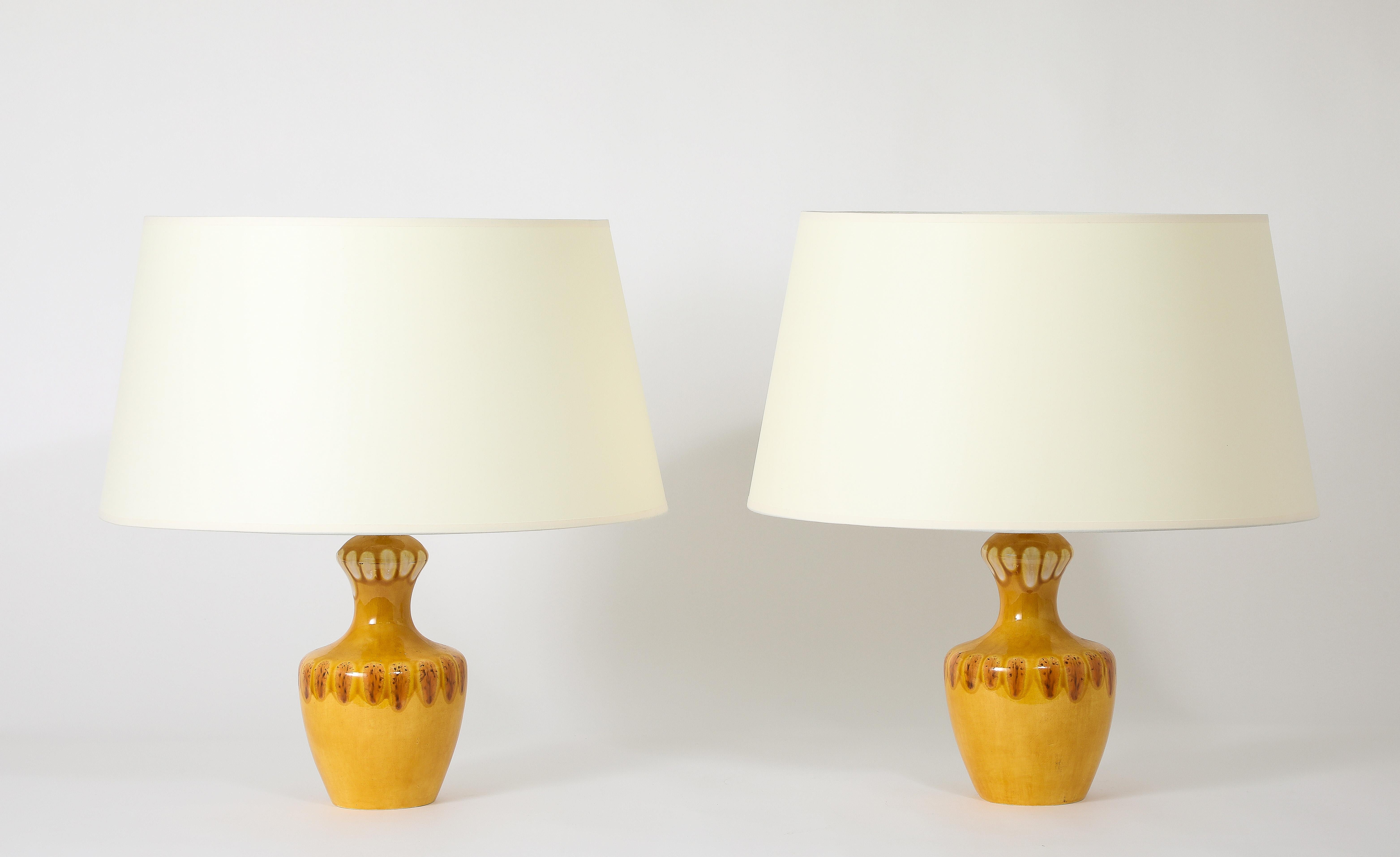 A pair of Balustre table lamps in a gradient orange glaze and abstract motif.