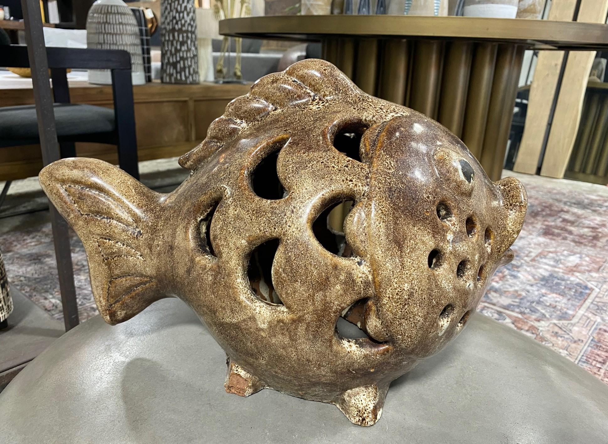 A rather curious and wonderful work - large, heavy ceramic fish sculpture - perhaps a pufferfish. 

The rich glaze and colors are fantastic. We have not seen another piece quite like it.

Would make for a fantastic accent piece in about any