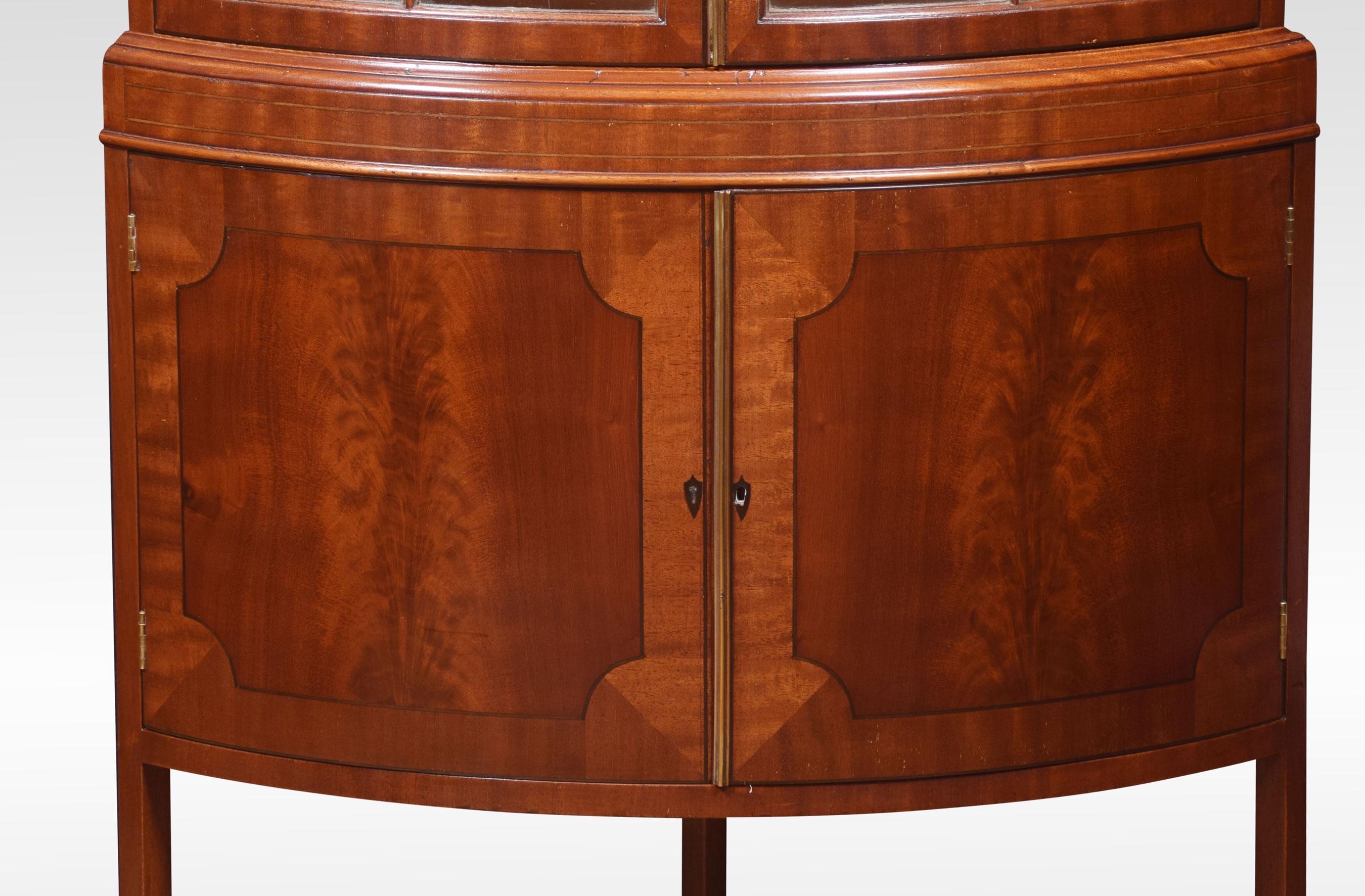 Mahogany standing corner cupboard, the bow-fronted beaded glazed door opening to reveal a shelved interior. Above a pair of mahogany paneled door opening to reveal large cupboard. All raised up on splayed legs.
Dimensions:
Height 72 inches
Width
