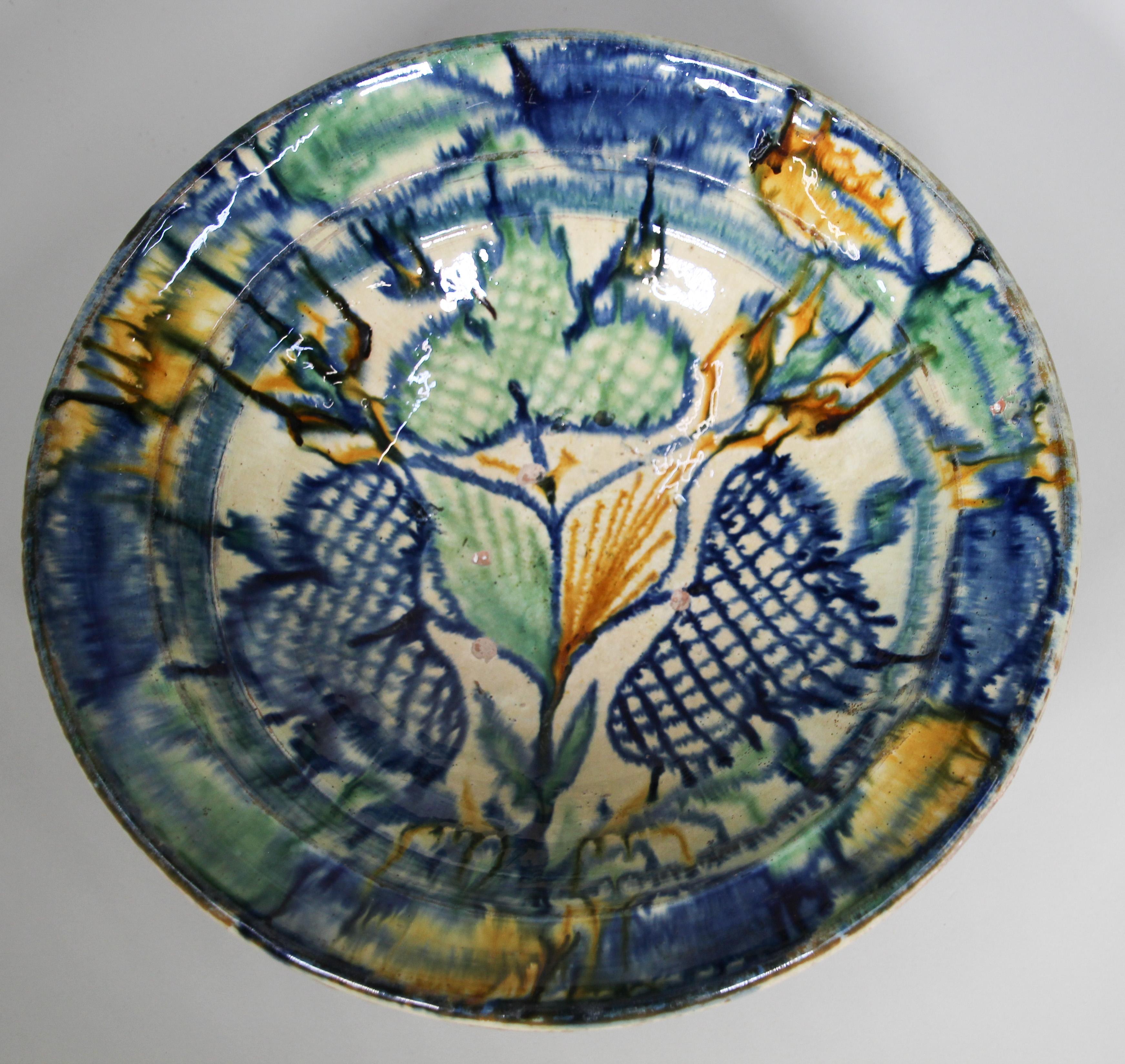 Glazed Mauresque Spanish Talavera pottery bowl ware.
Hispano-Moresque earthenware dish majolica in polychrome Moorish patterns.
Islamic pottery vessel hand painted in splashes of colors in cobalt blue, saffron yellow and teal floral decoration, very