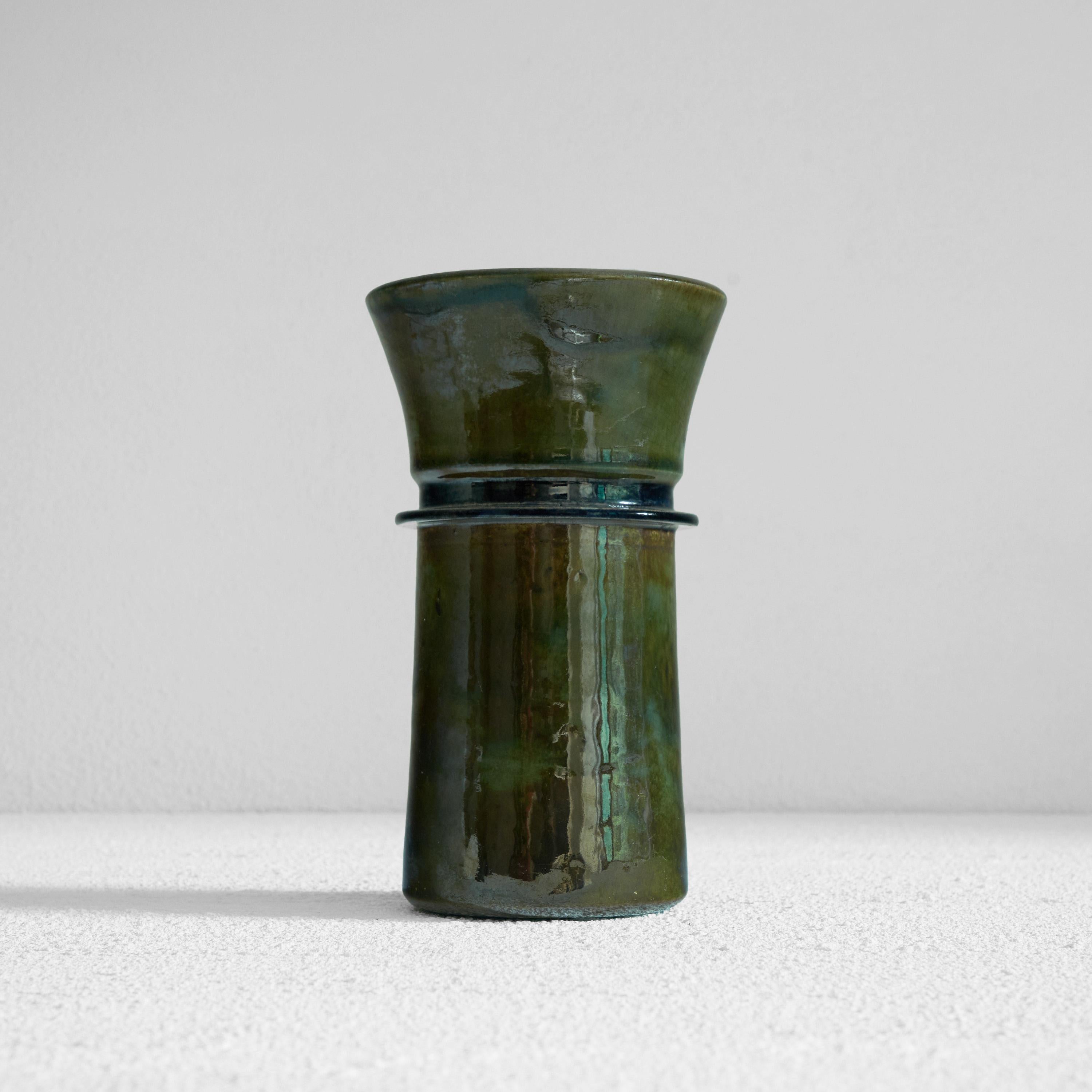 Glazed Studio Pottery vase in green and blue. Early to mid 20th century. 

This is a beautiful metallic glazed studio pottery vase with a distinct shape. Great simple but strong lines. Thick and rich glaze in dark metallic green with a blue ring