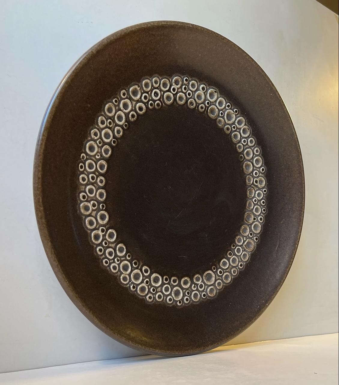 Glazed Pottery centerpiece dish or bowl by Frederik Ravnild. It features a circular decor mimicking the surface/texture of the Moons surface. Manufactured by Ravnild in Denmark during the 1970s. Unusual piece of Scandinavian Modern pottery.