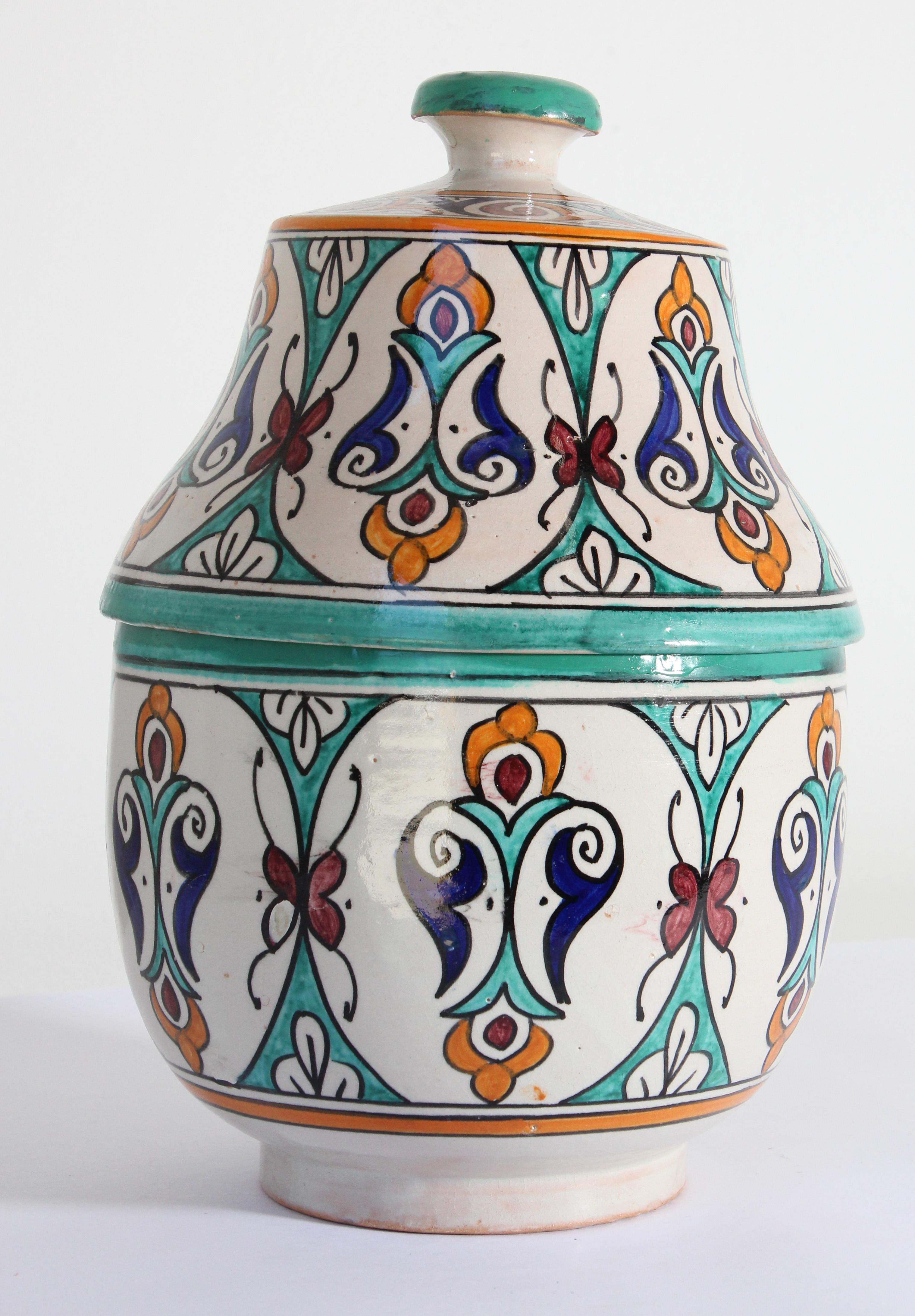 Moorish ceramic Moroccan glazed polychrome jar tureen with cover.
Hand painted ceramic Jubbana, handcrafted by skilled Moroccan artisans in Fez Morocco.
Moorish designs in turquoise, cobalt blue, teal, saffron yellow, prune and ivory