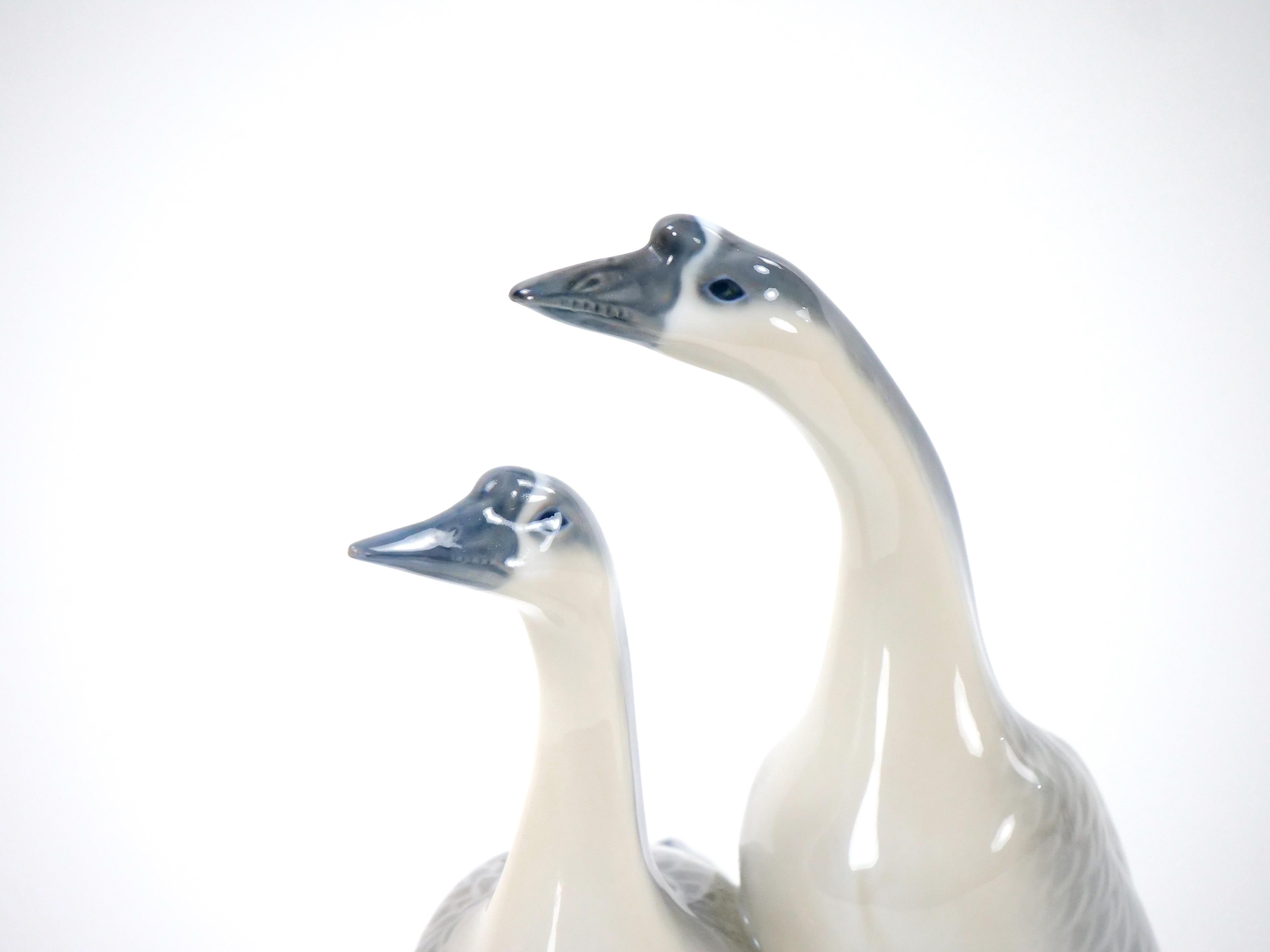 Indulge in the timeless elegance of Glazed Porcelain with this exquisite pair of Royal Copenhagen Decorative Duck Sculptures. Meticulously crafted, these sculptures are a testament to the brand's legacy of exceptional design and craftsmanship. The