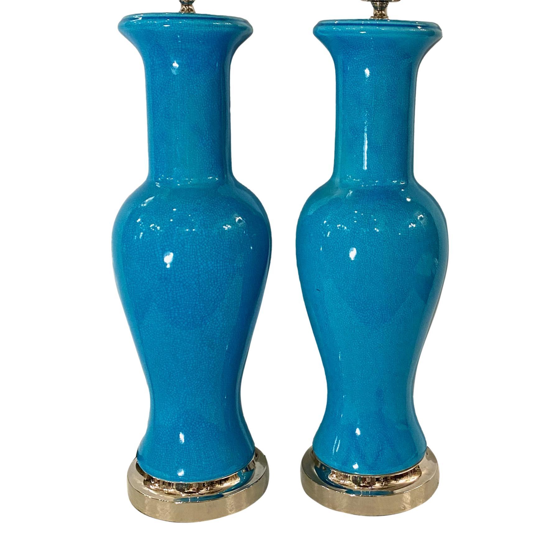 A pair of circa 1940's French vase-shaped turquoise blue crackle-glazed porcelain table lamps with nickel-plated bases.

Measurements
Height of body: 2o