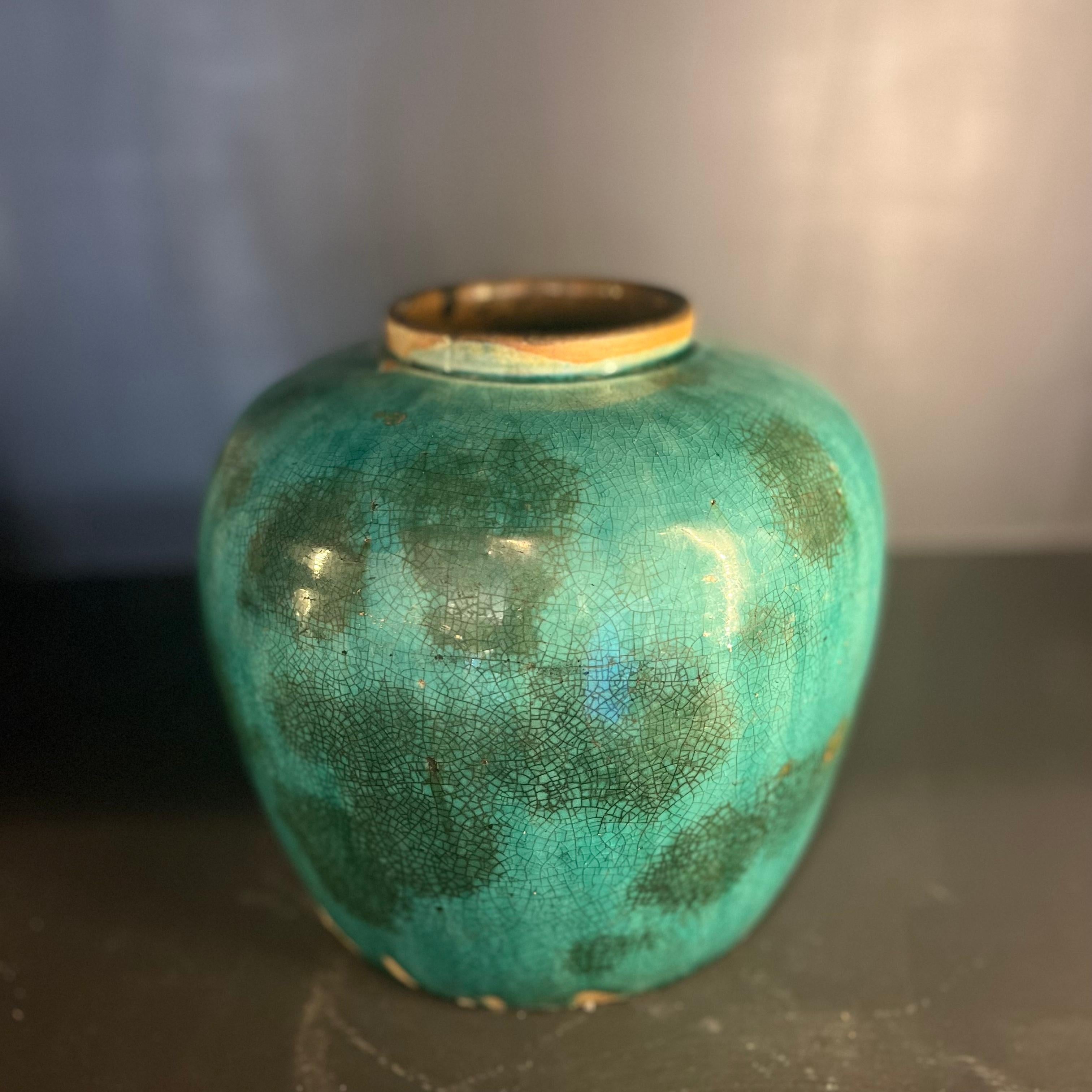 Ceramic stoneware pot with a crackled green glaze, hailing from mid-18th century China. The color quality here is fabulous—the juiciest, most pellucid marine blue-green, with soft washes of a darker hue dotting the surface in an irregular pattern.