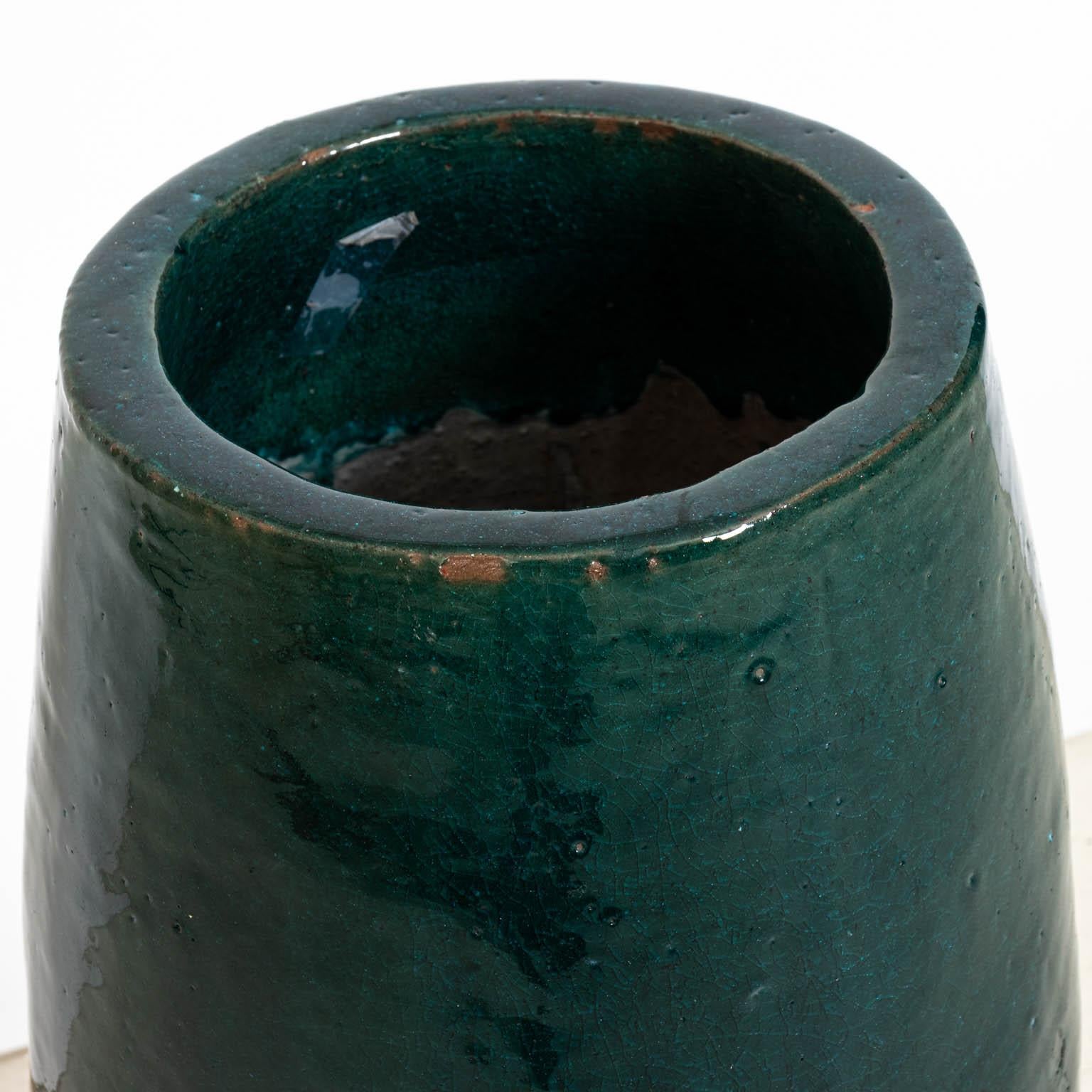 Green glazed pottery umbrella stand, circa 1980s. Please note of wear consistent with age including minor glaze loss, chips, and paint loss.