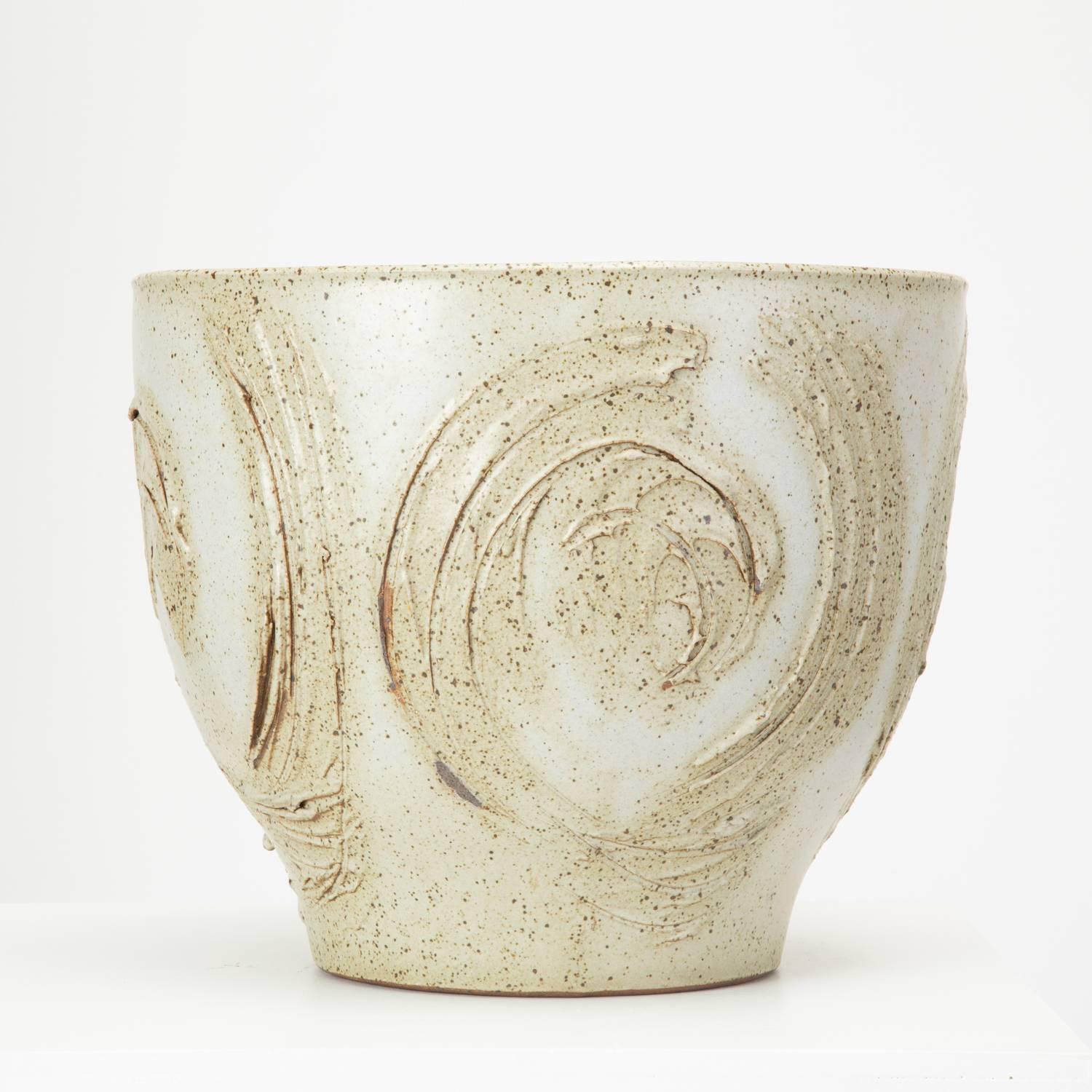 A gray spatter-glazed urn planter designed by David Cressey for Architectural Pottery's 1960s Pro/Artisan collection. The slip-cast piece has a bowl shape, tapering to a smaller foot and features painterly ridges and incisions in a rounded pattern