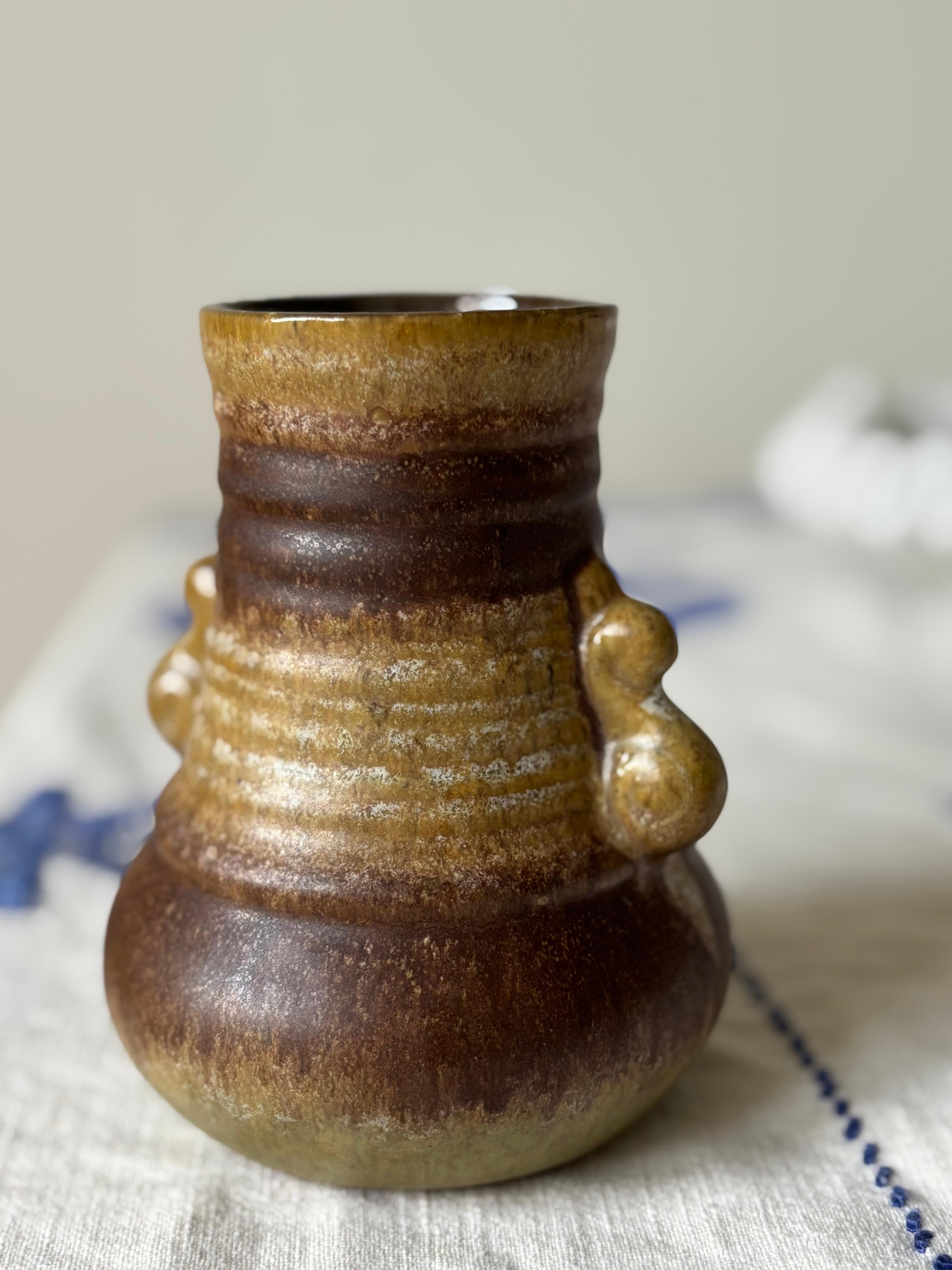 Vintage ceramic vase with layered running glaze in light and dark brown colors over light olive on the base. Soft organic bubble shaped handles on the sides. 
Manufactured in the 1960s. 
Great vintage condition. 