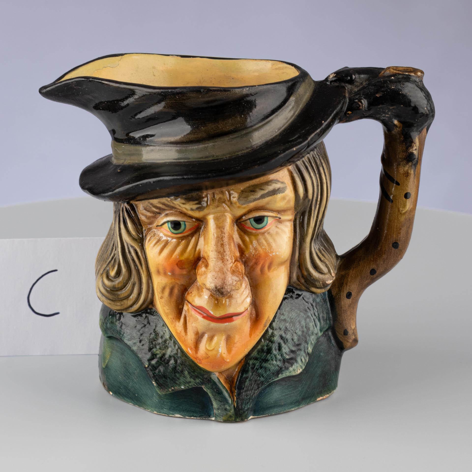 Caricature jug in the shape of an old man with a hat

Origin: England (Staffordshire or Devon, attributed)
Material: Glazed stoneware
Date: Mid-20th century (approx. 1940–1960)

Dimensions:
H × D: approx. 12 × 13 cm

Description:
Figuratively