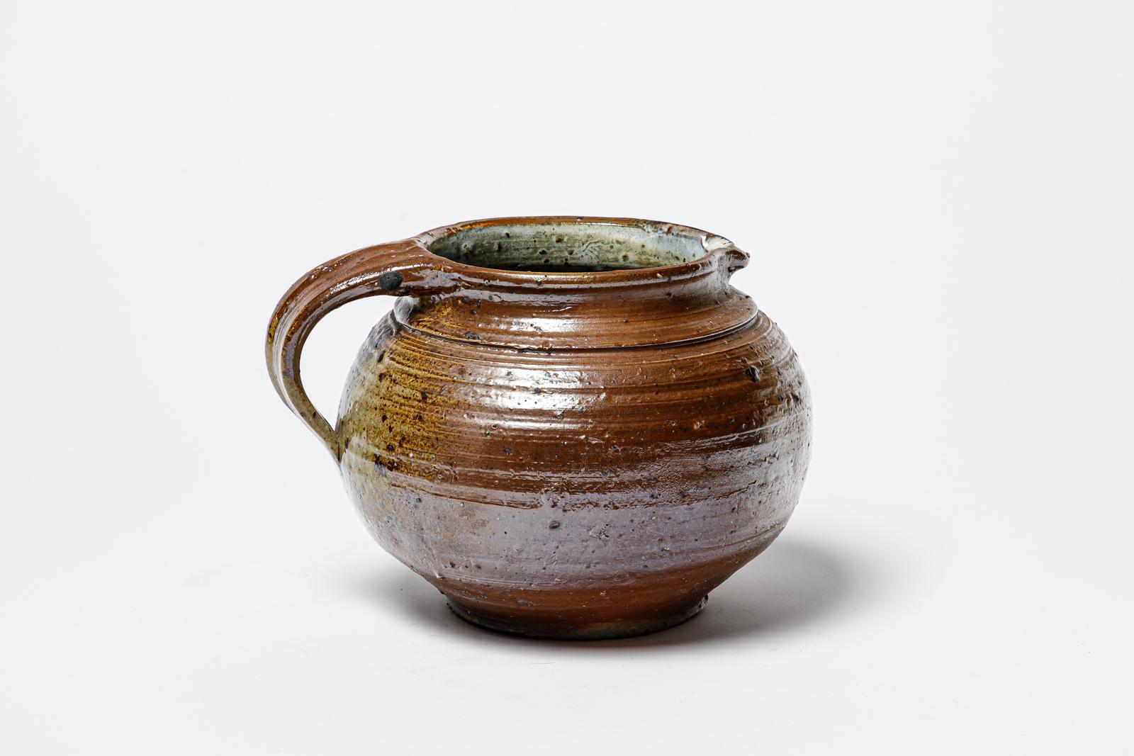 Glazed stoneware pitcher by Michel Gardelle. 
Artist signature under the base. Circa 1980. 
H : 7.1’ x 9’ x 7.9’ inches.
