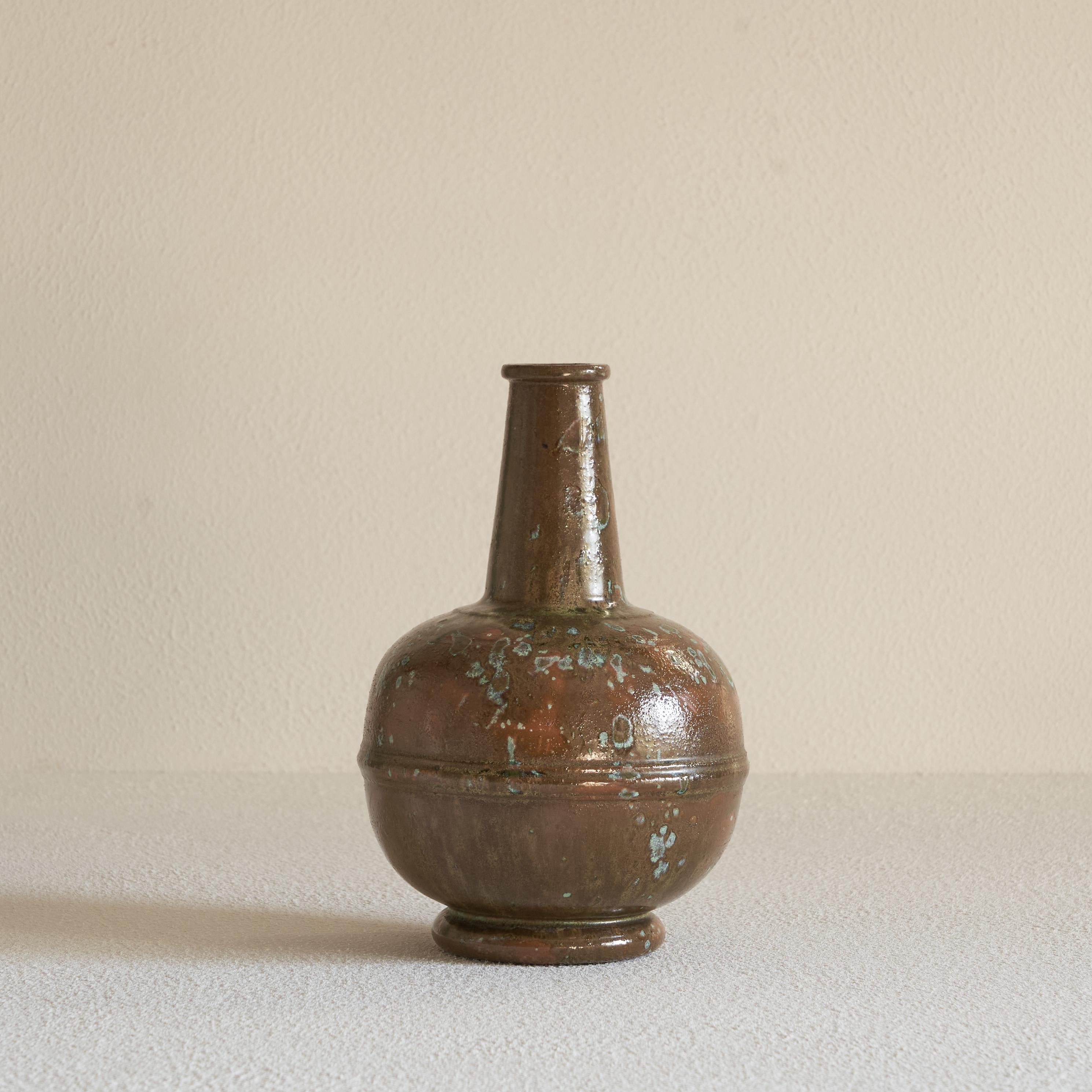 Glazed ceramic vase, early 20th century.

This is a beautifully glazed Studio Pottery vase made in the early 20th century. It has a very distinct shape with a spherical base and a slender spout and interesting details like the raised edge on the